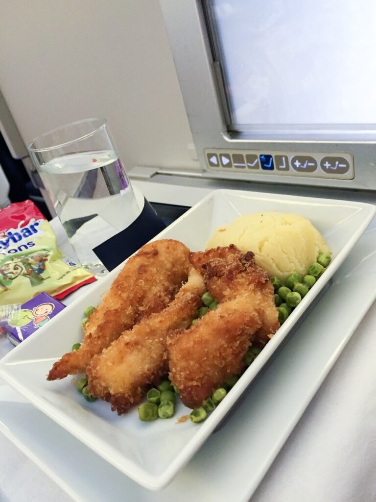 Chicken nuggets main entree course with peas and mashed potatoes