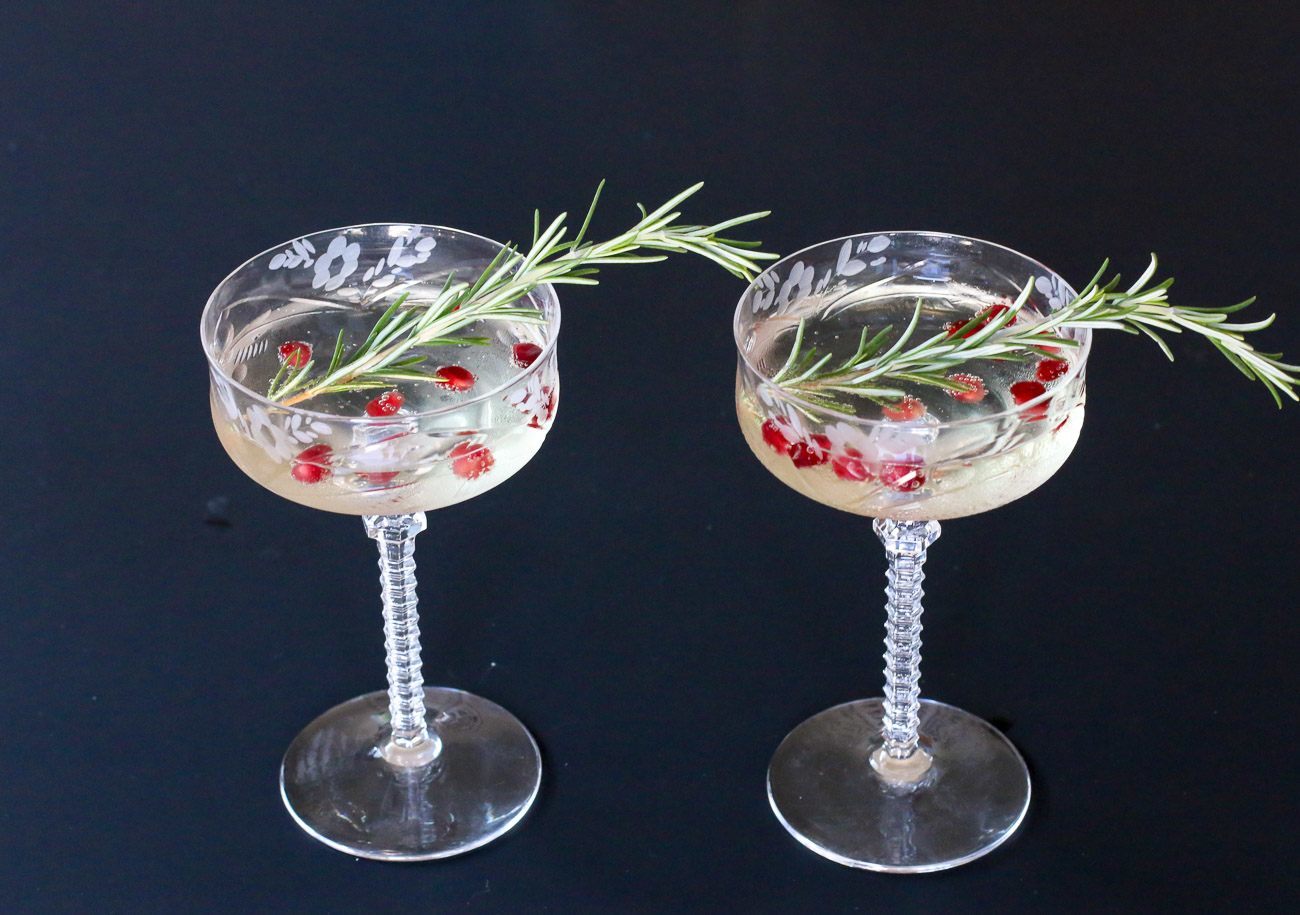 It's easy to garnish a champagne glass with herbs like rosemary and pomegranate seeds (perfect for the holidays) or even just a sprig of lavender.