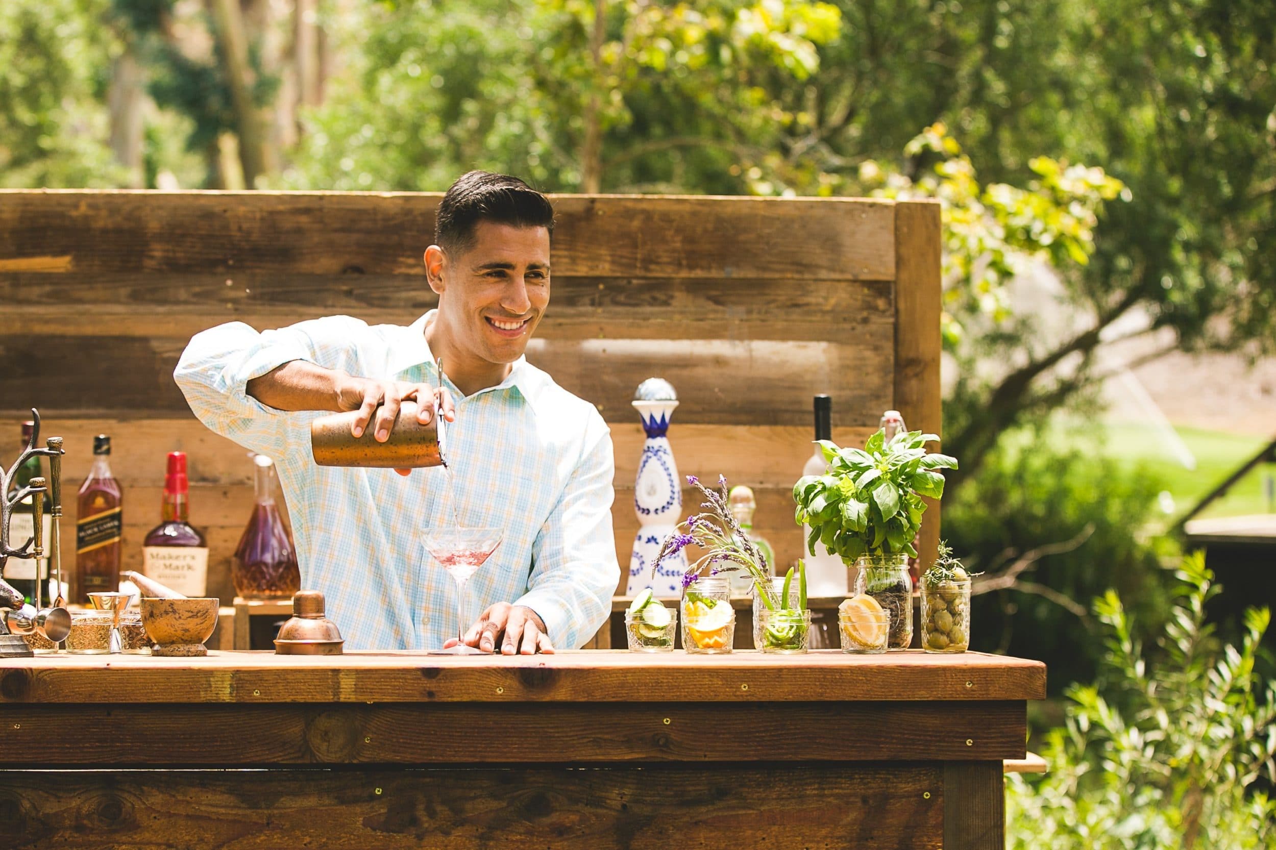 A bartender pours drinks for guests