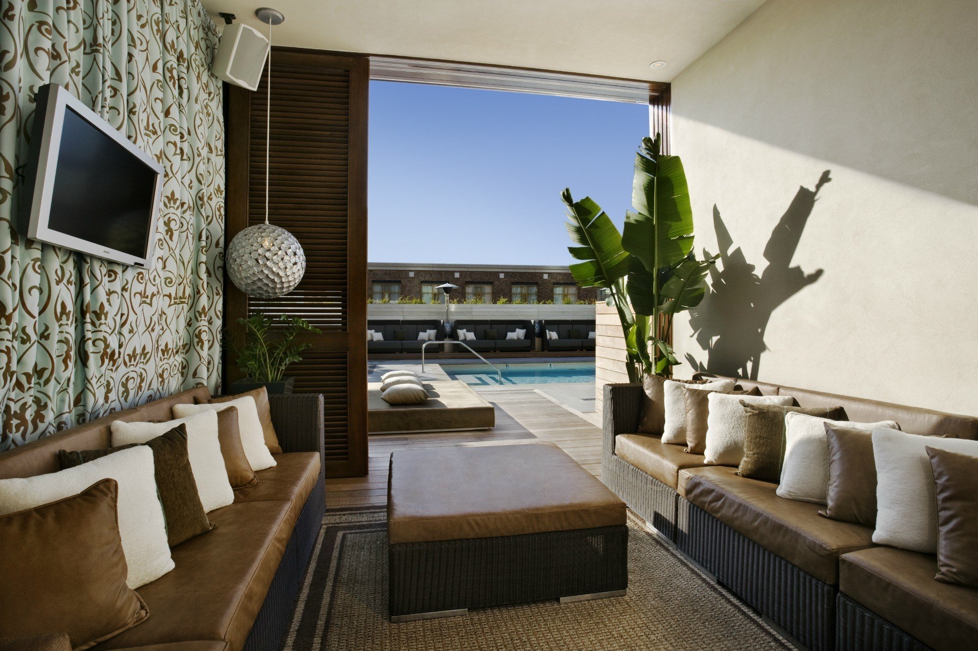 Hard Rock Hotel San Diego pool party vibes from a huge shaded cabana with a TV. 