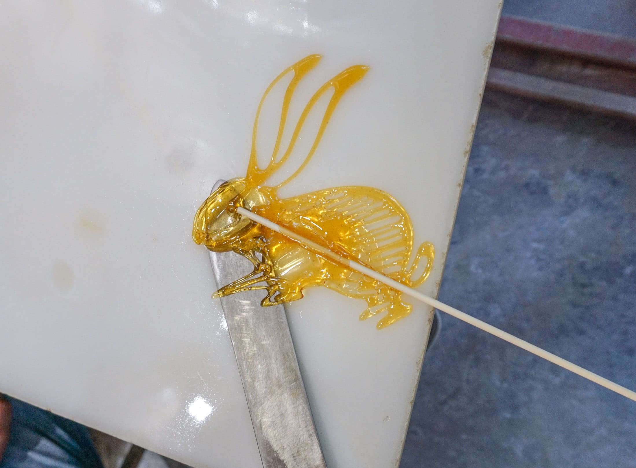 A rabbit painted with sugar being removed from the slab.