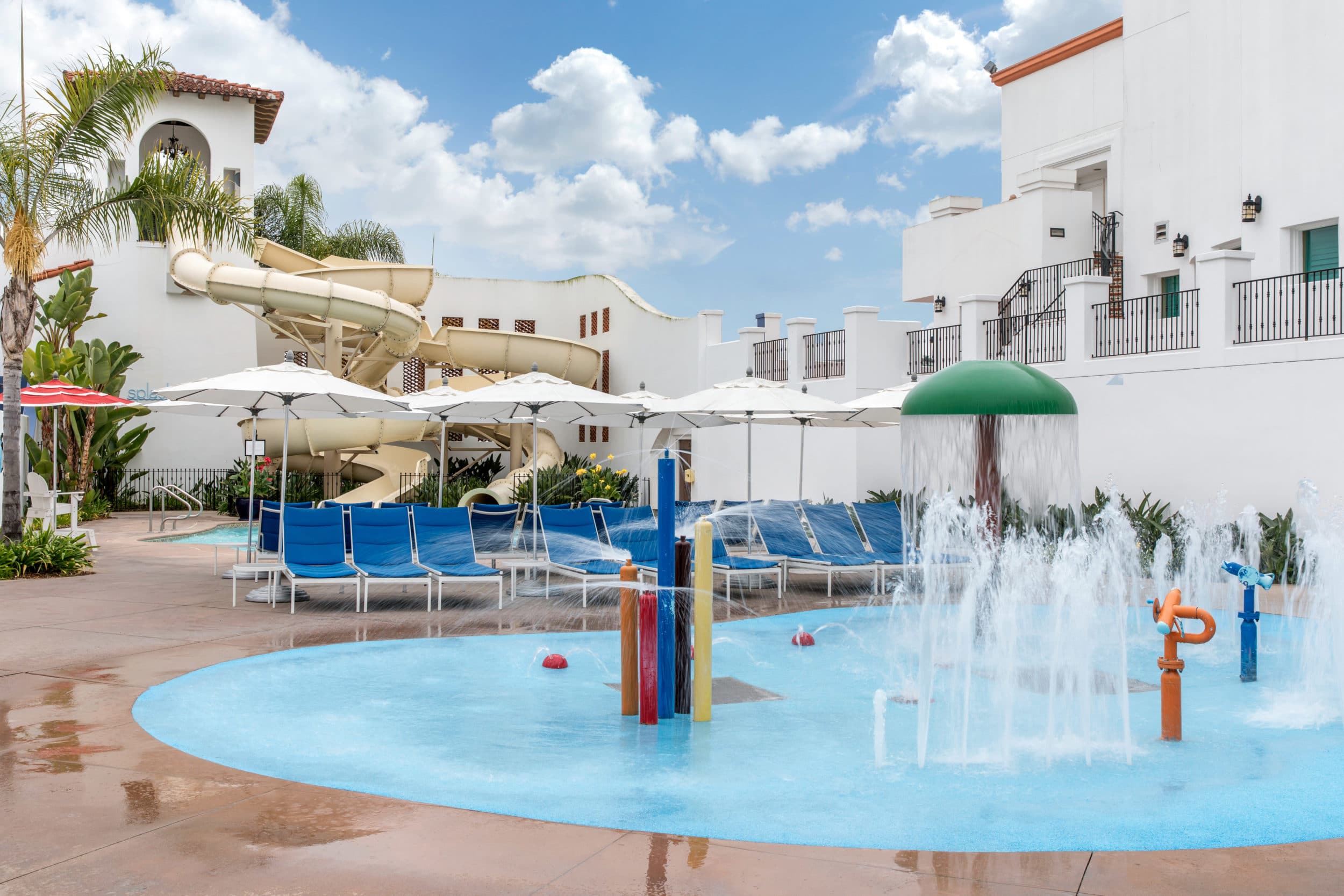 The Splash Landing waterslide and splash pad at the Omni La Costa pool for families.