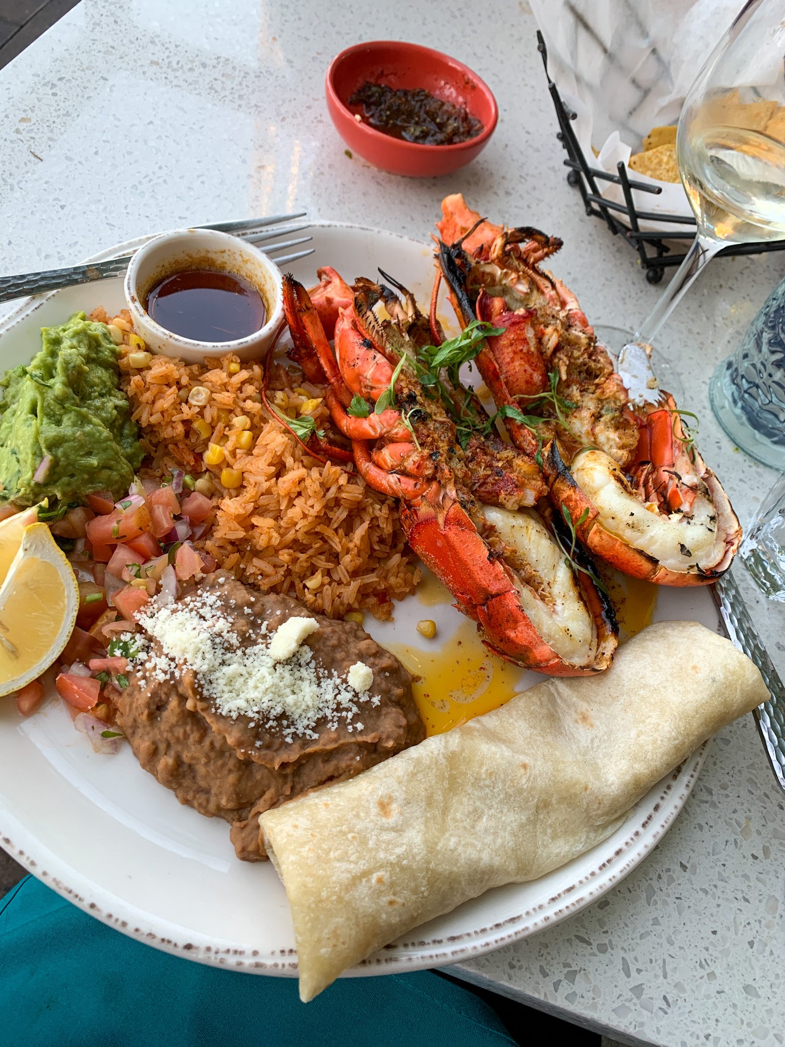 My plate of Puerto Nuevo lobster on a table at Pueblo restaurant in Pacific Beach.