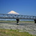 A shinkansen bullet train passing by Mt. Fuji