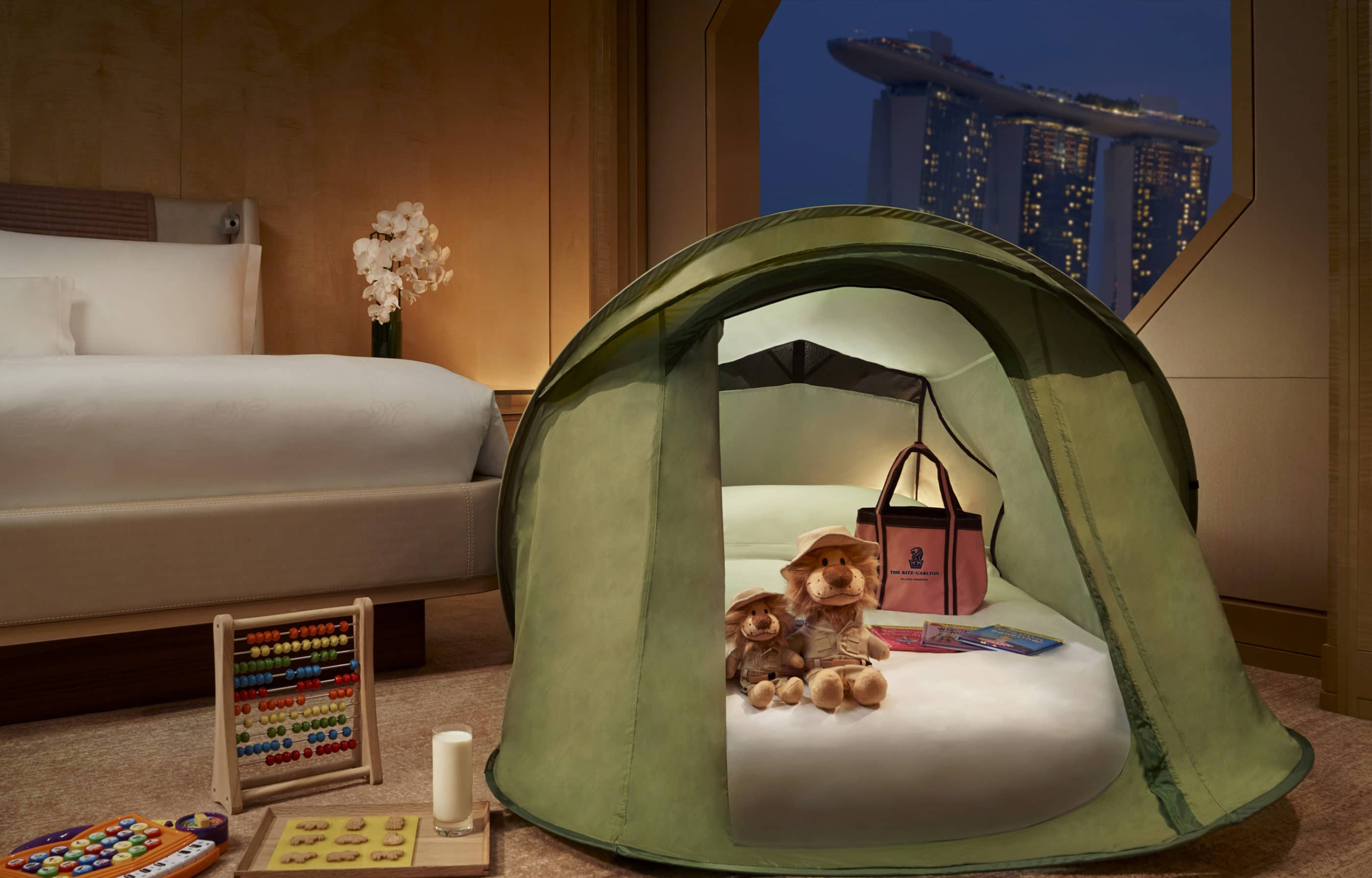 A Ritz Kids pop-up tend with stuffed animals and a small mattress inside for small kids to sleep in.