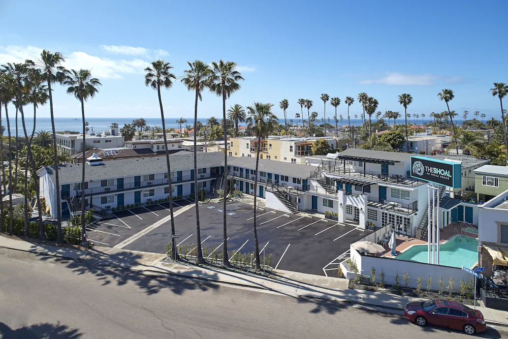Aerial view of The Shoal that shows the location in Windansea, the motel parking setup and pool.