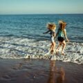 two girls playing at the water's edge at the beach in Santa Barbara