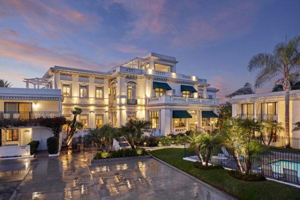 The exterior of Glorietta Bay Inn, a top Coronado hotel, at dusk.