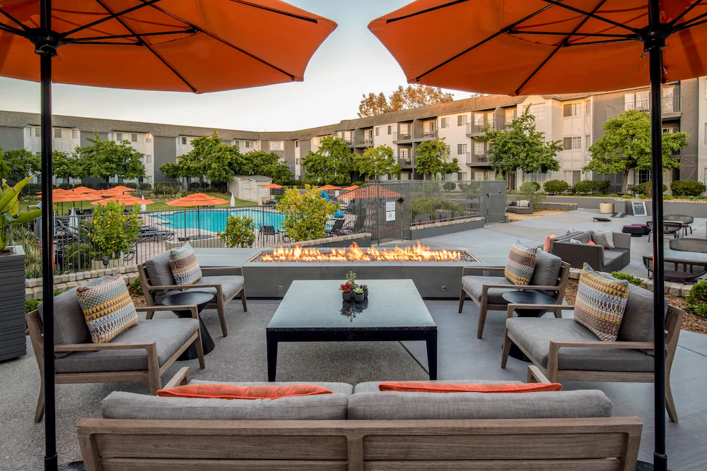 Restaurant seating and fire pit near the pool at Hilton Del Mar.