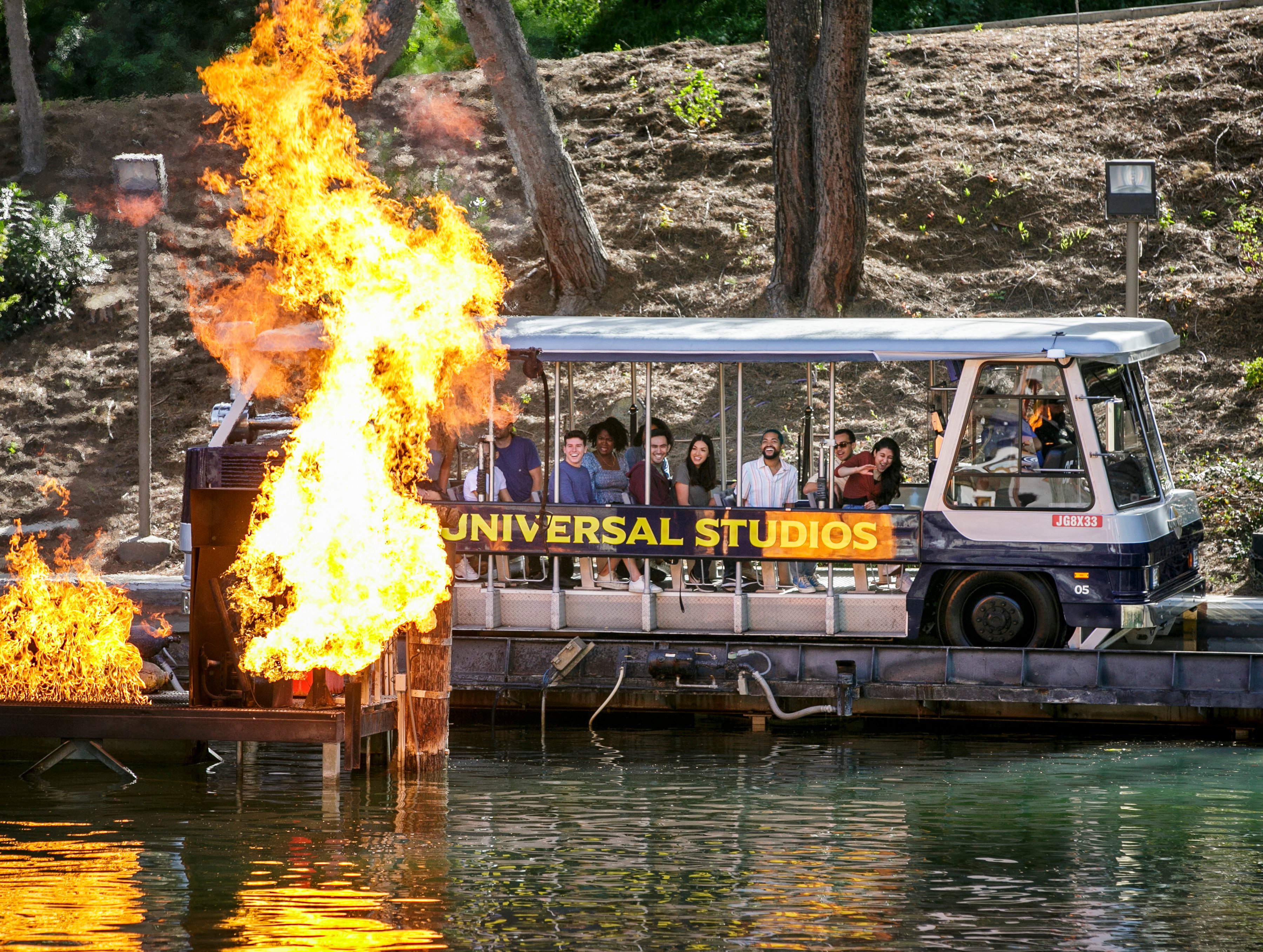 A World Famous Studio Tour Bus passes by fire during the tour.