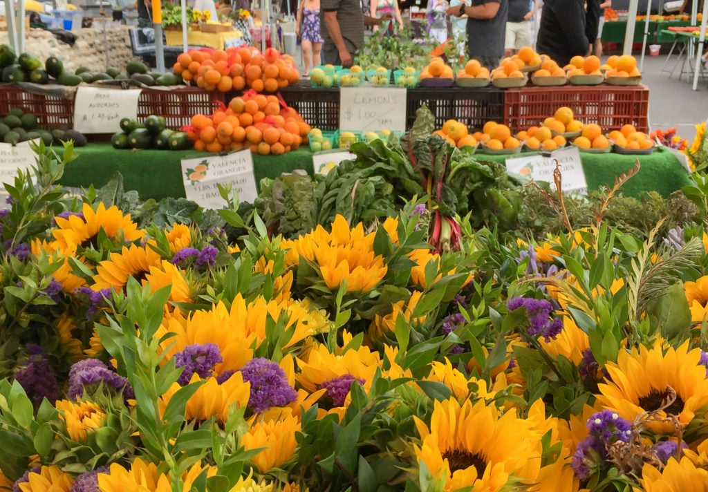 Sunflowers and produce on display at La Jolla Open Aire Market