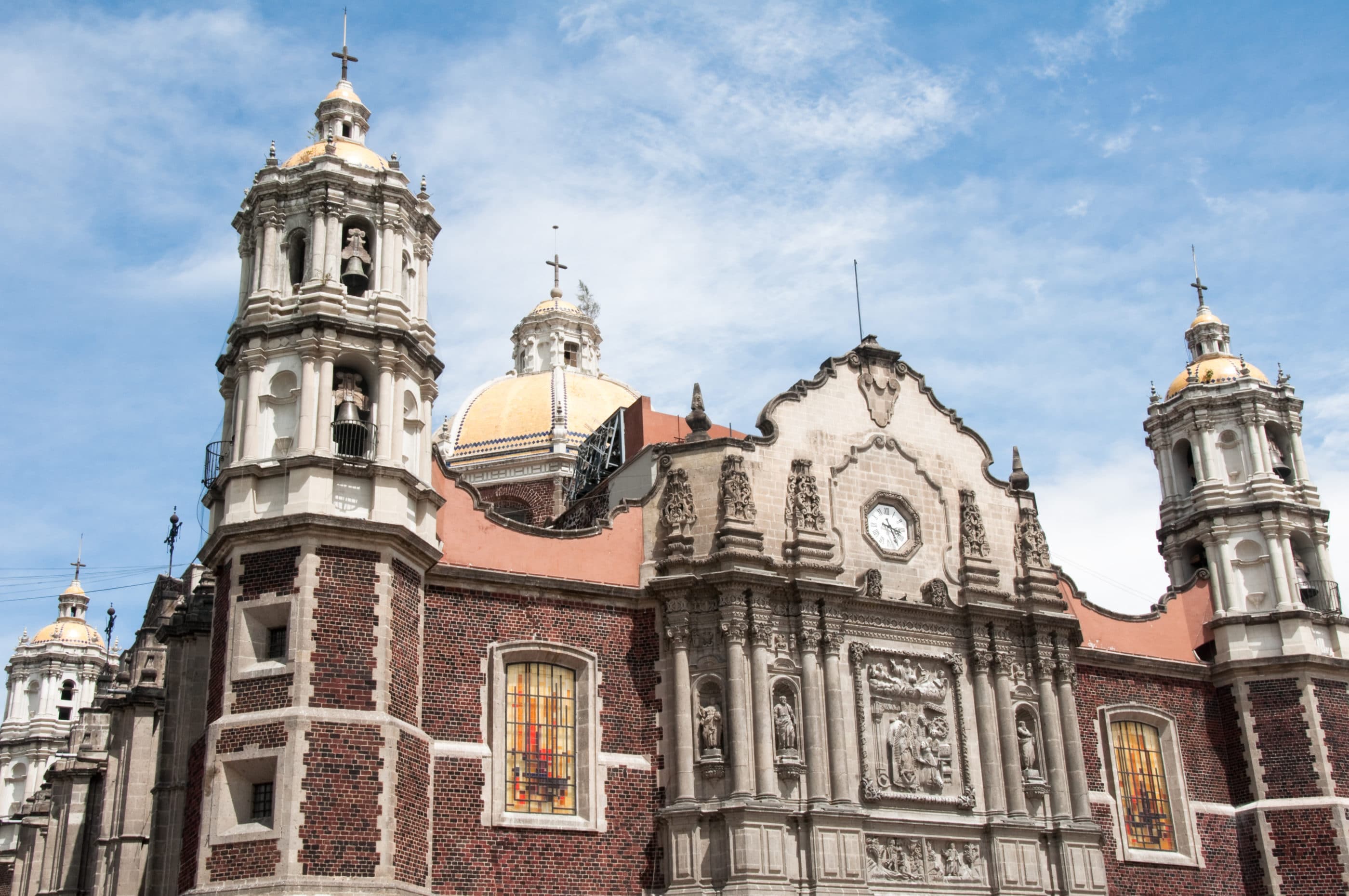 Exterior facade of the Bas&iacute;lica de Santa Maria de Guadalupe against the sky.