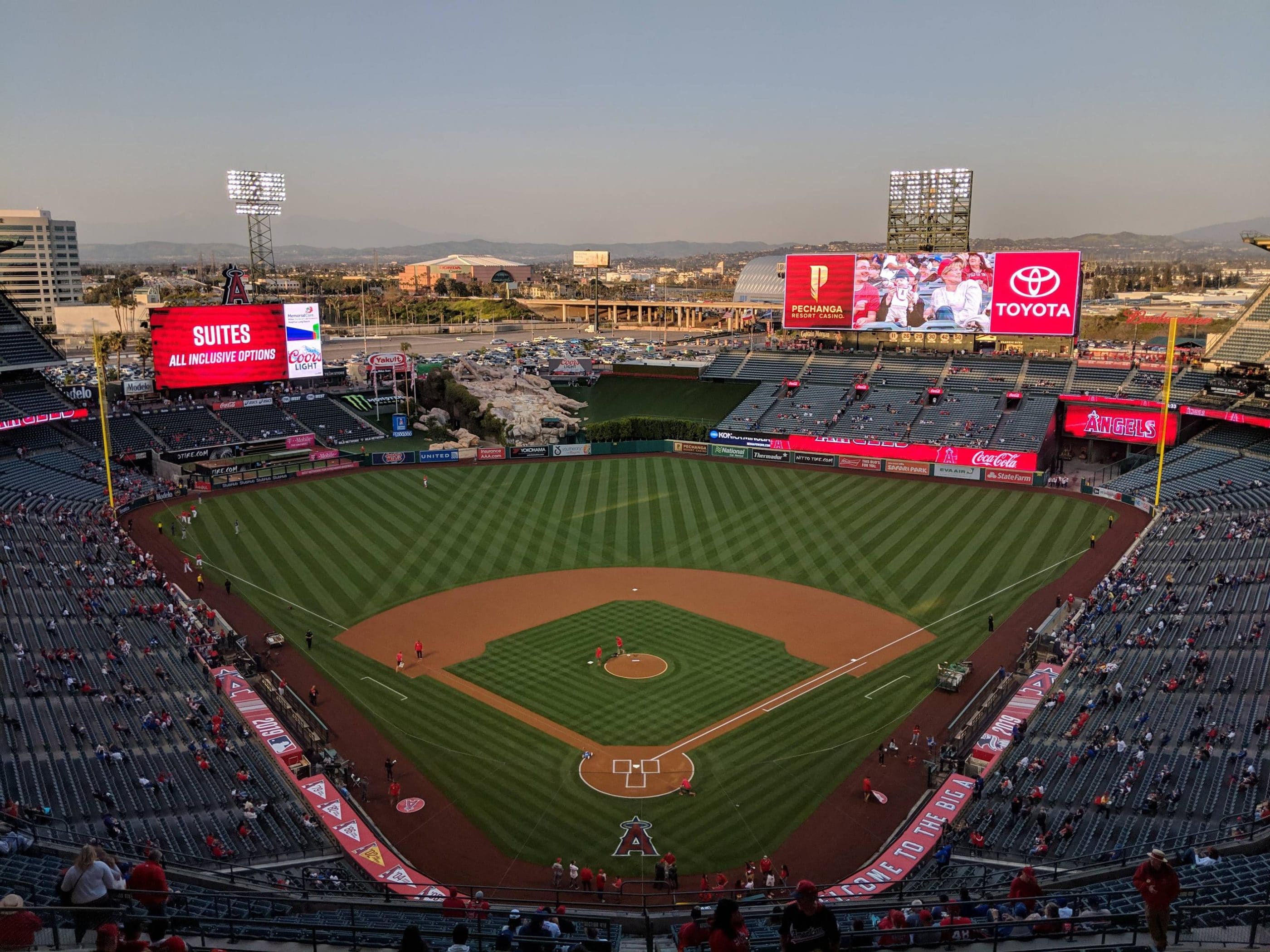 Aerial view of Angel Stadium at dusk during a baseball game.