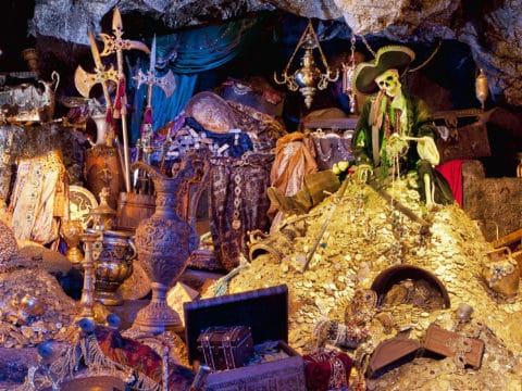 A skeleton sits in treasure on Pirates of the Caribbean, one of the most popular Disneyland rides.