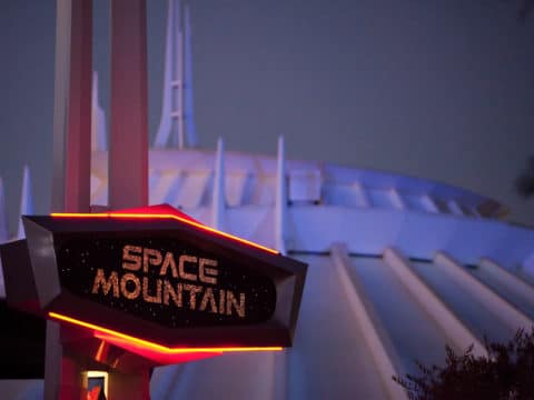 The Space Mountain sign in front of the ride's famous galactic mountain dome.