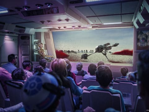 Guests watch the screen on the interior of the Star Tours, a Star Wars ride at Disneyland.