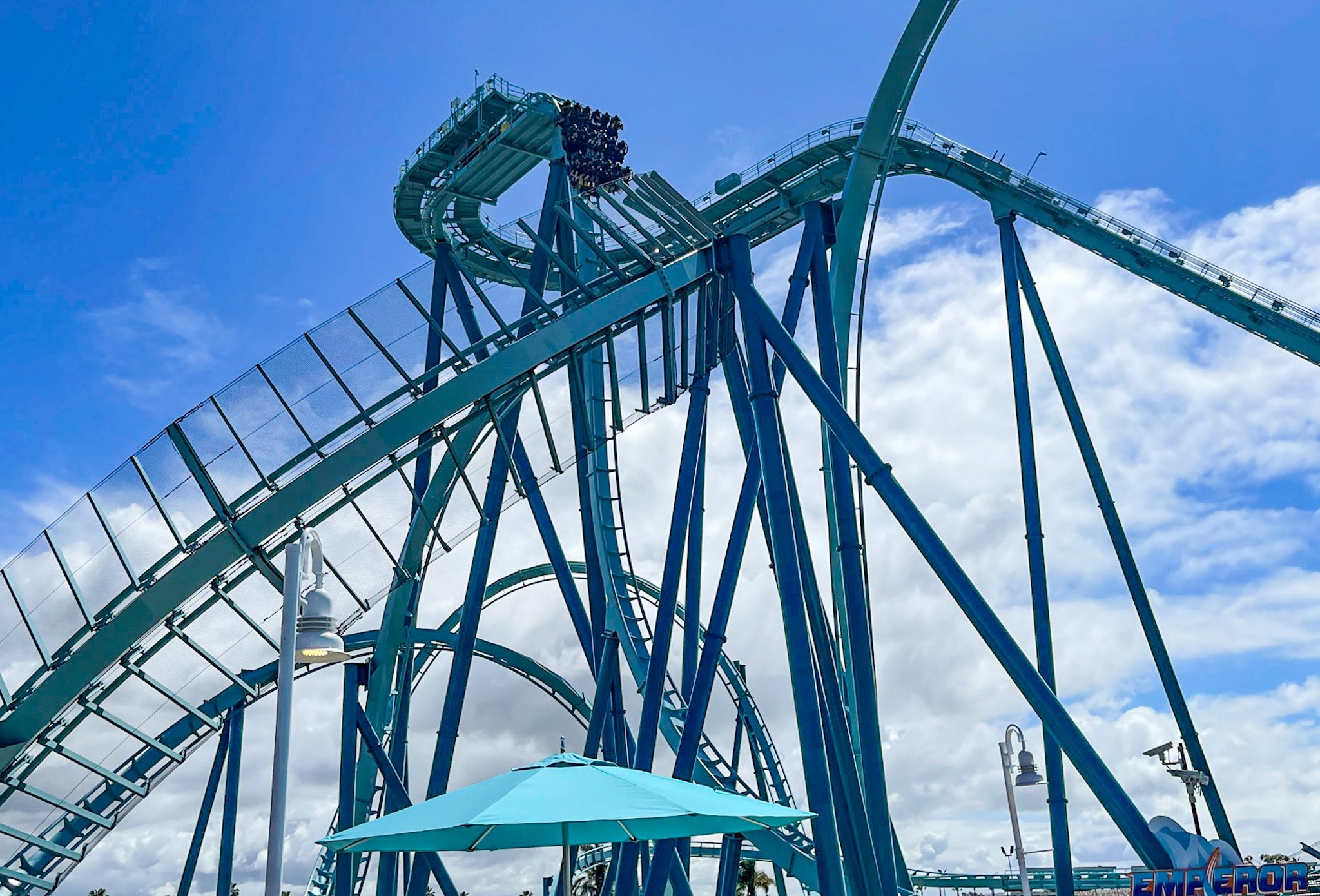 The Emperor roller coaster with riders about to drop down a steep drop.