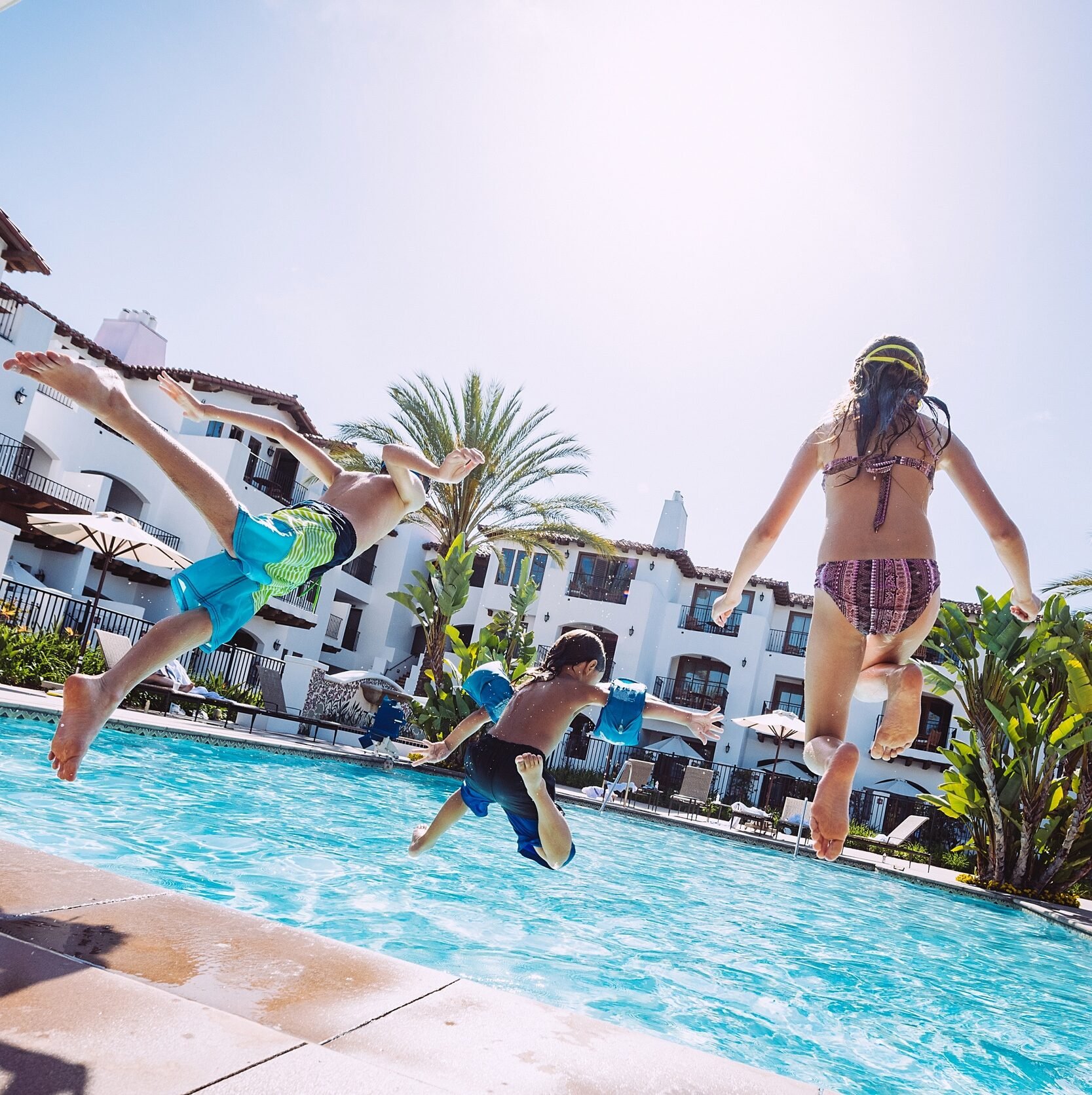 Kids jump into the Villa Pool