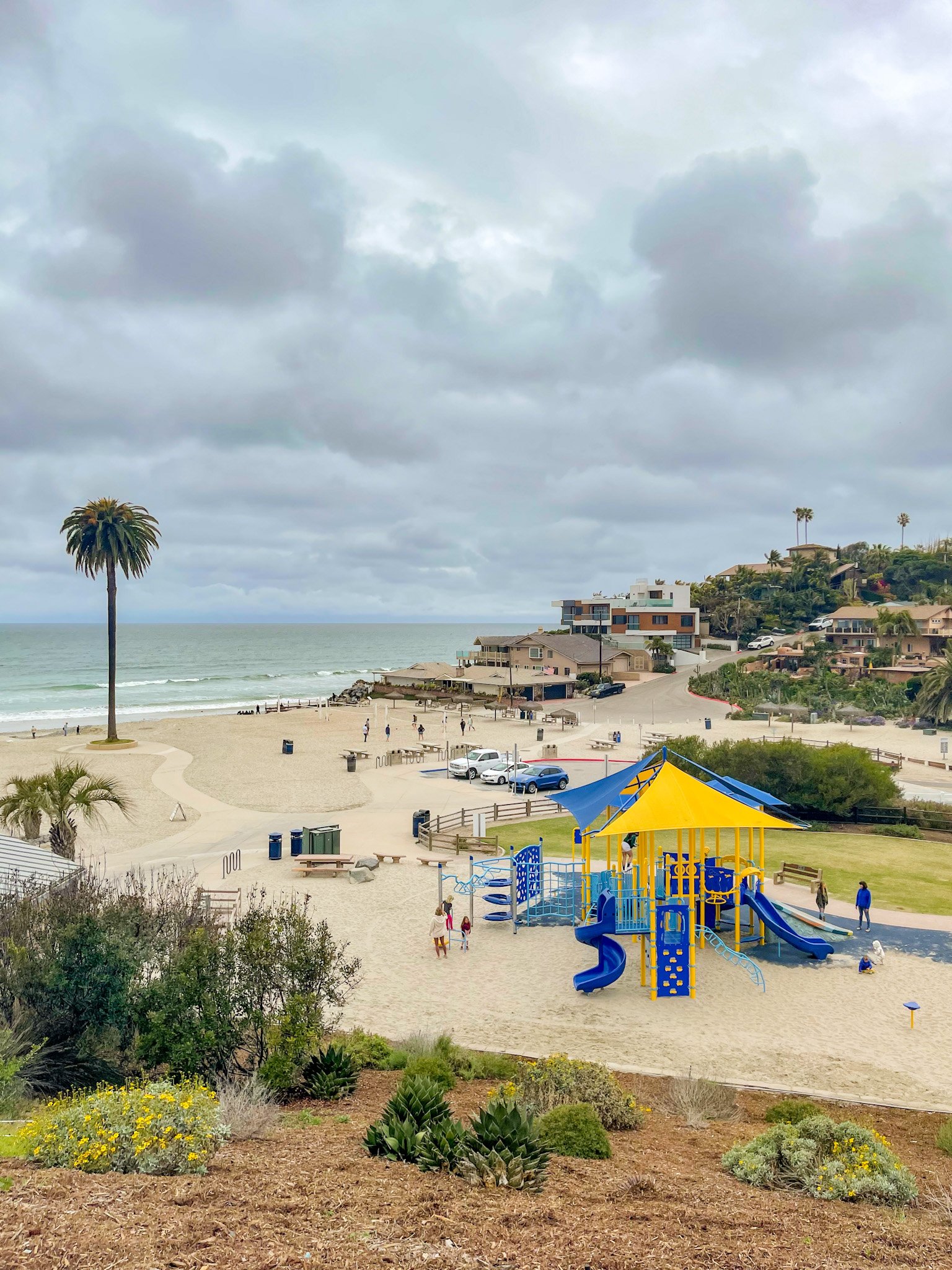 The play structure in use by kids at the Moonlight Beach playground.