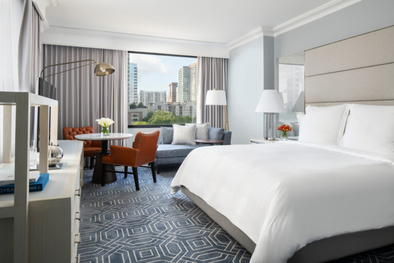 The bedroom and seating area inside the Four Seasons Atlanta Premier Suite.