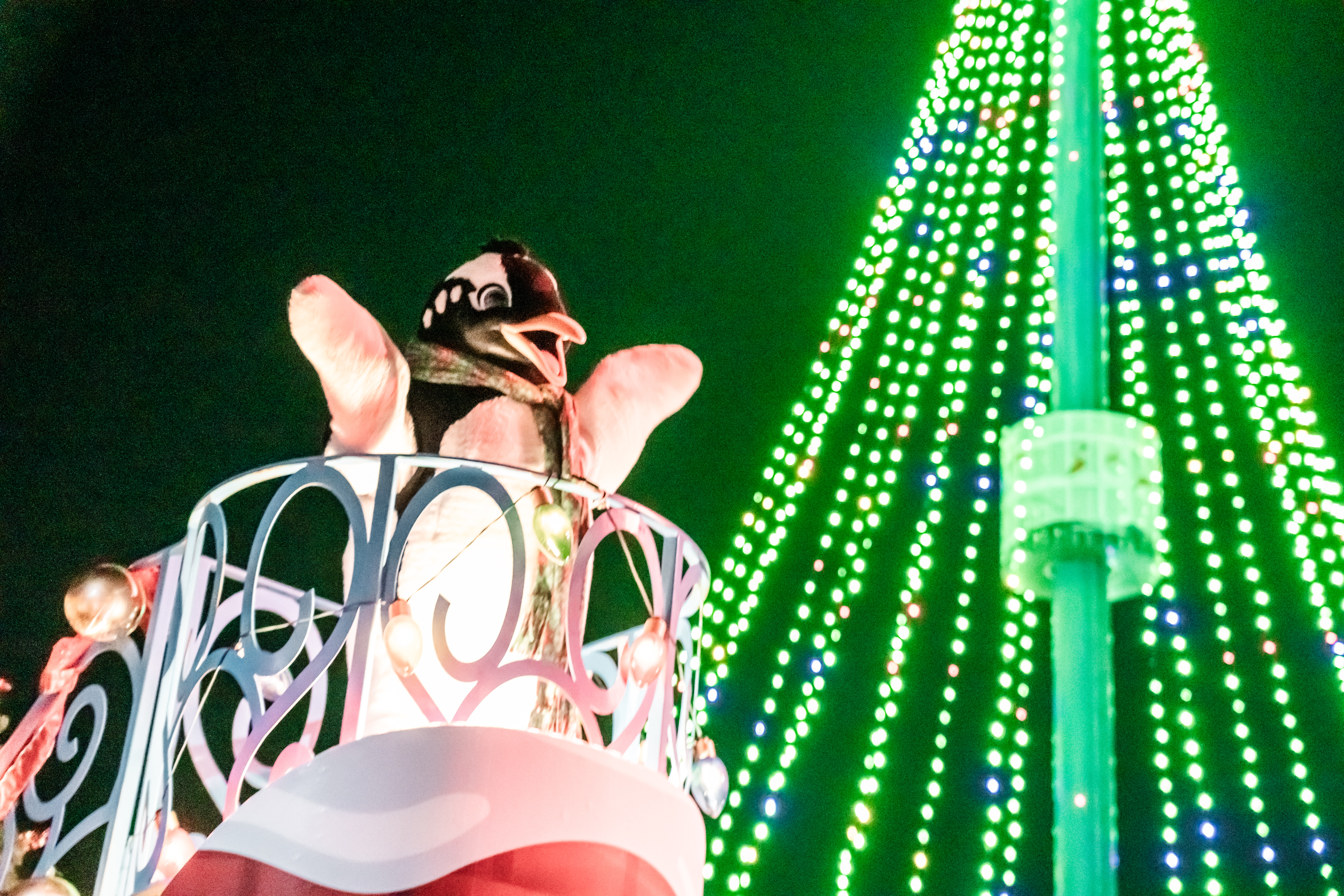 penguin mascot in a float parade