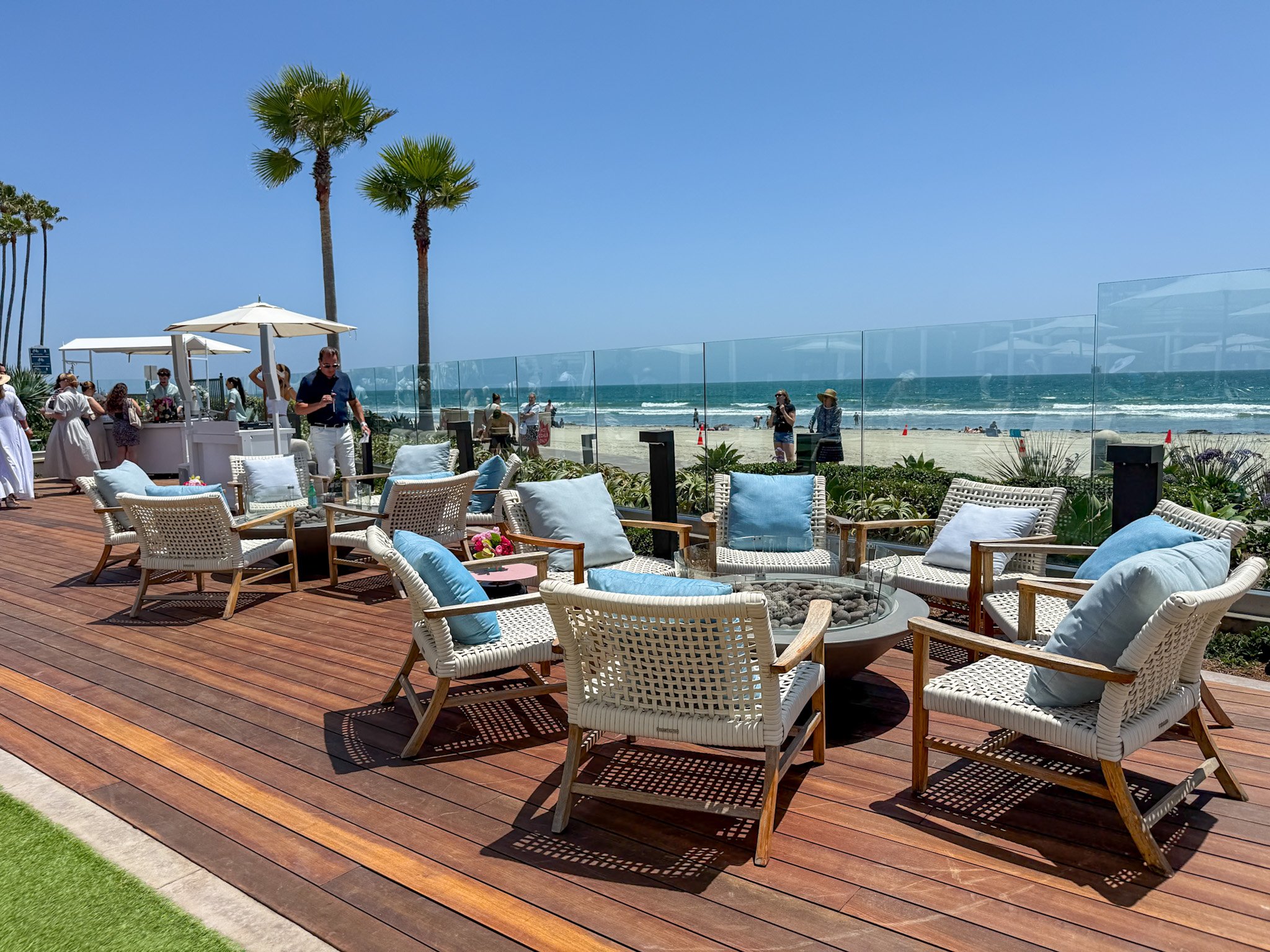 Oceanfront fire pit seating at the edge of the pool deck.