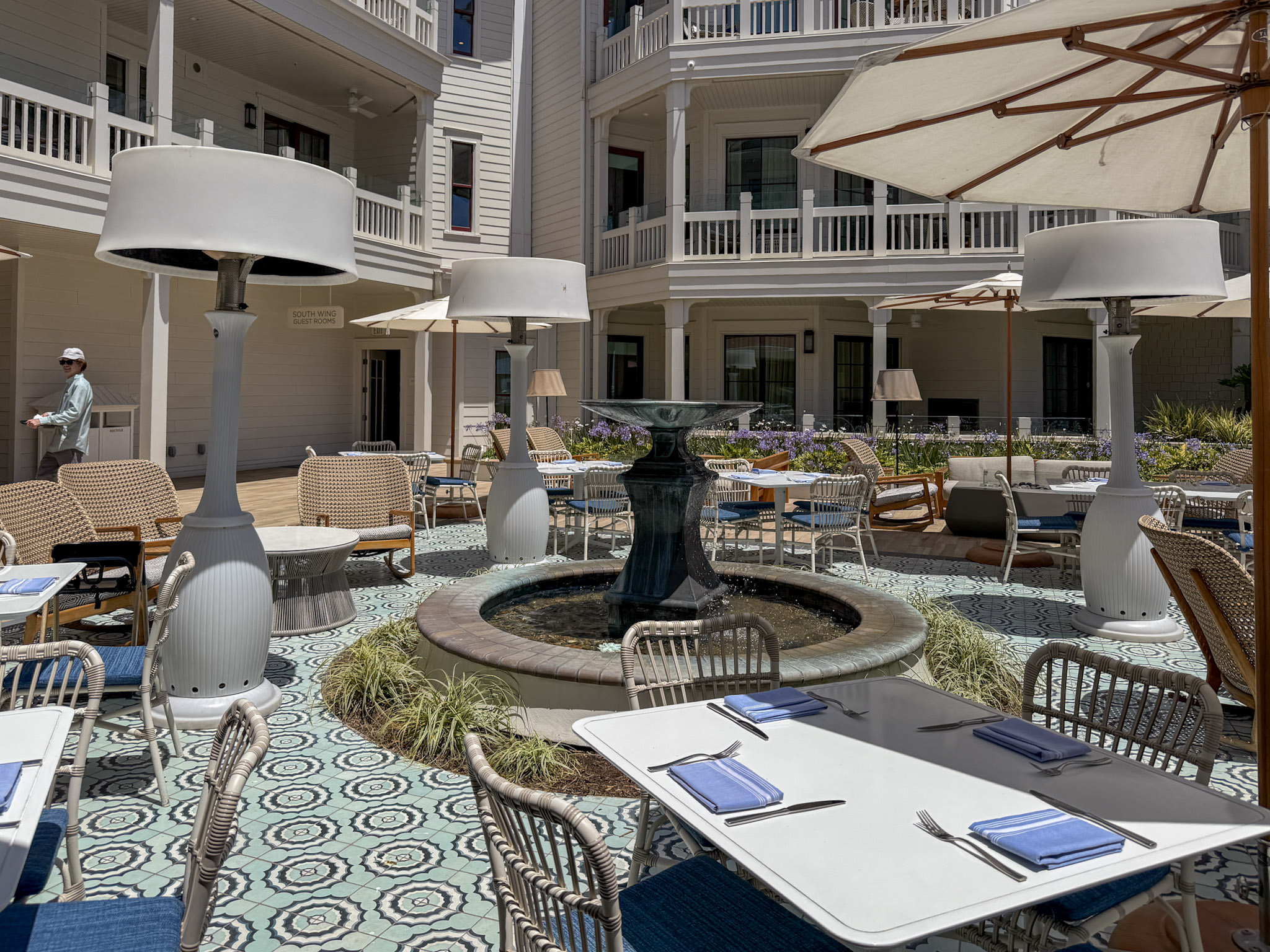 Shore House Bistro outdoor tables shaded by umbrellas.
