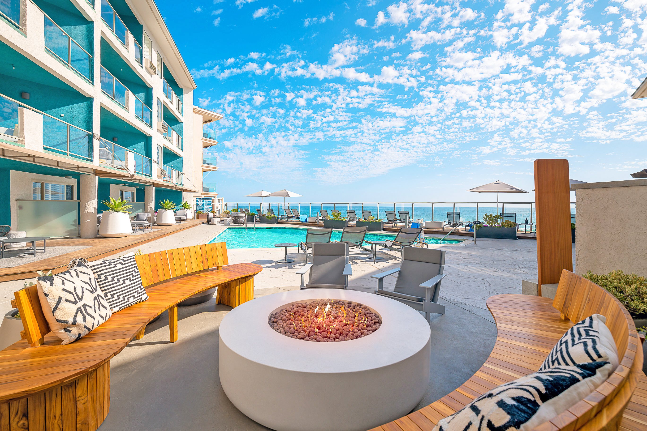 Fire pit by the outdoor swimming pool at Beach Terrace