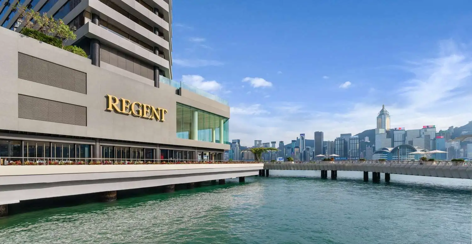 Exterior view of The Regent Hong Kong with the Central skyline and harbour in view.
