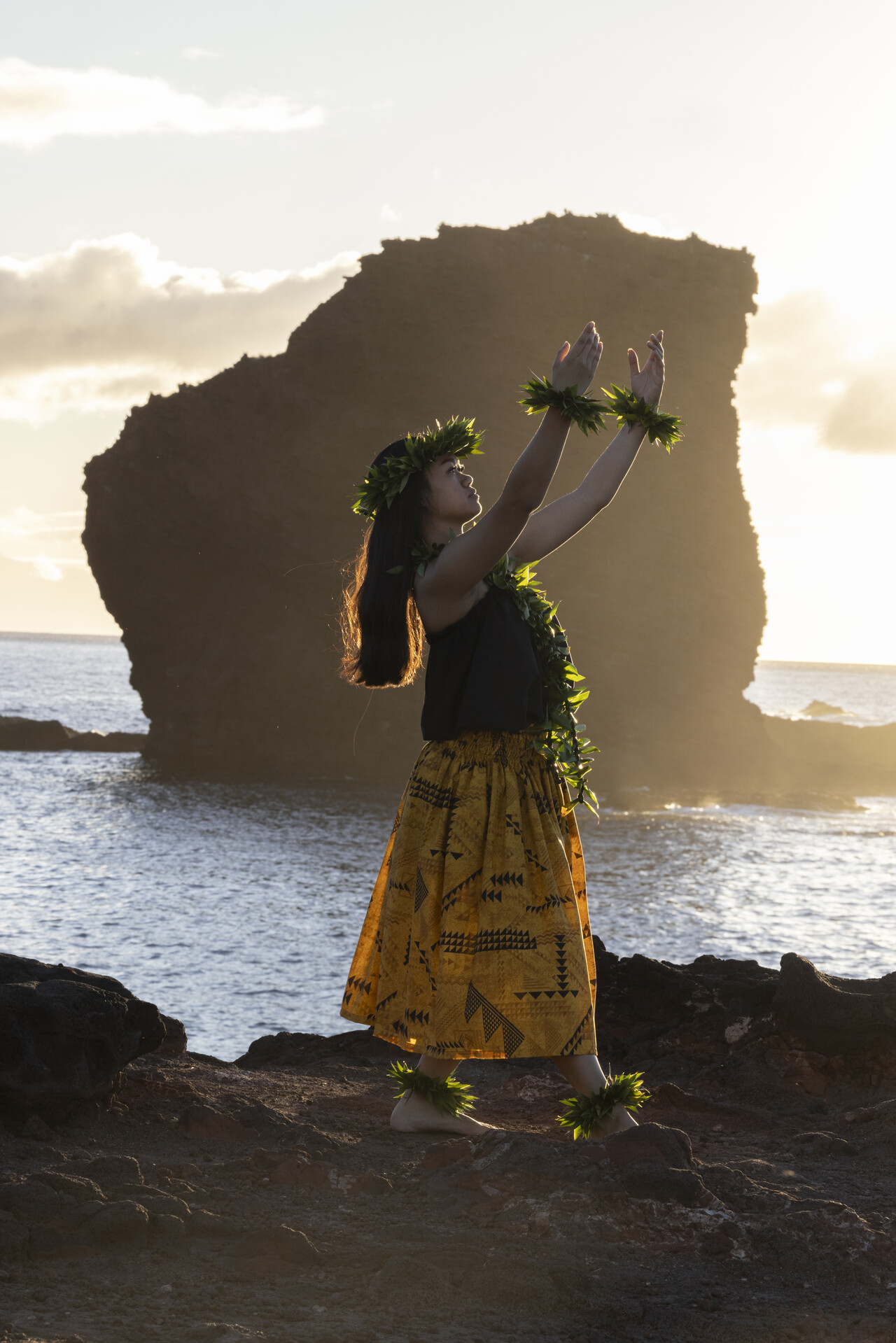 a girl doing hawaiian dance at the shore