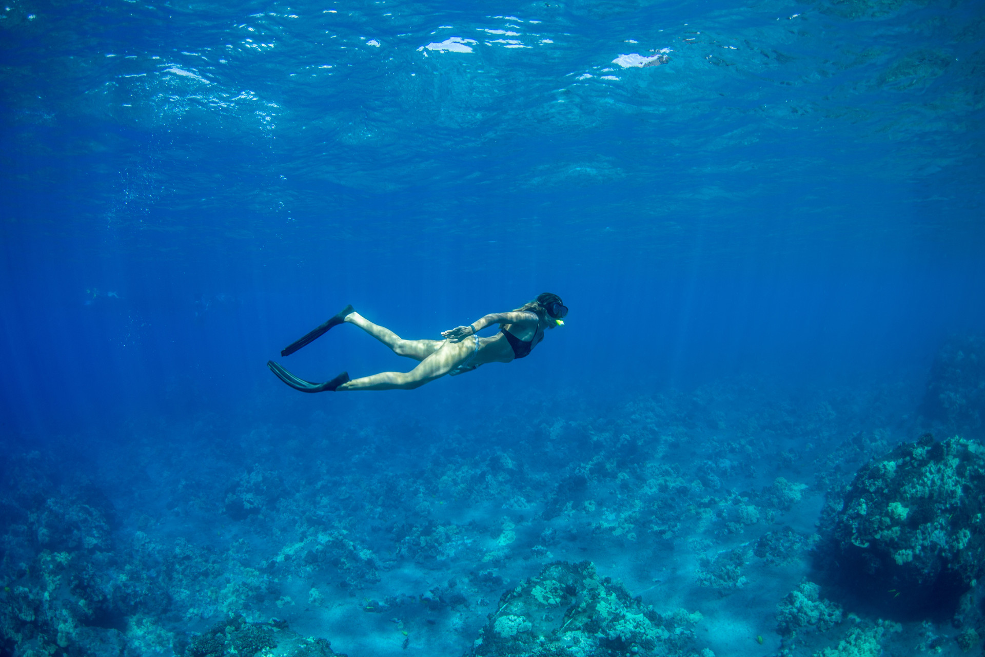 A woman exploring under water