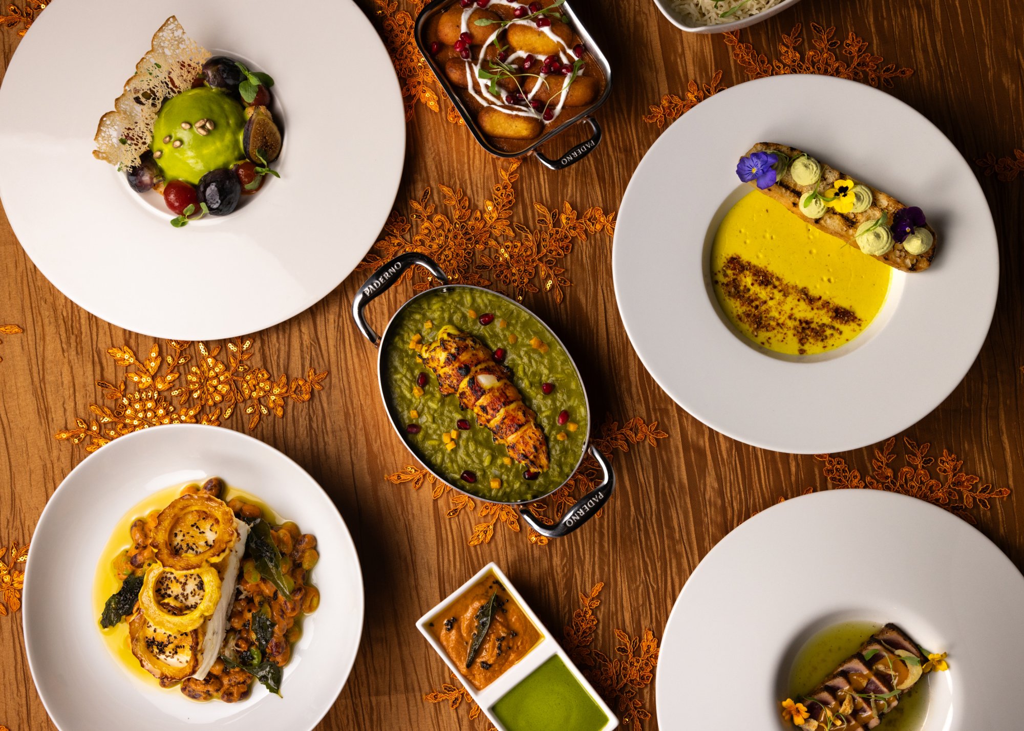 Top down view of beautifully plated curry and other dishes from KAHANI.