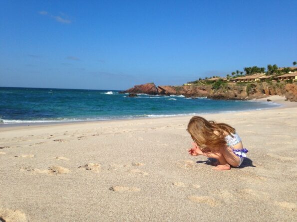 My daughter plays in the sand on the beach at Four Seasons Punta Mita.
