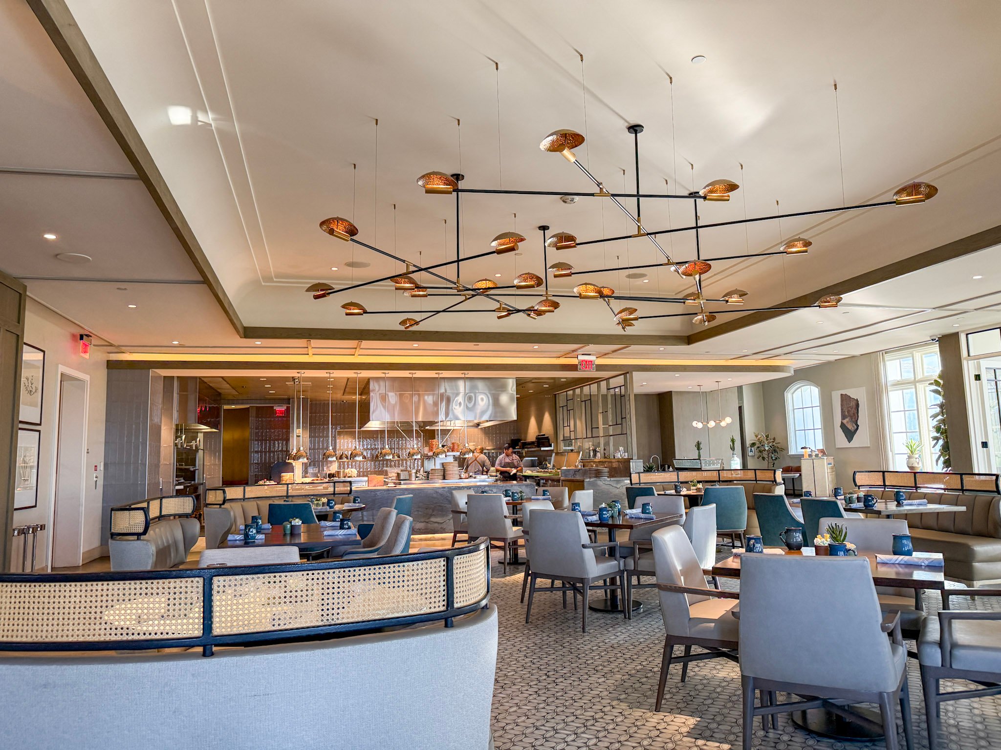 Dining tables with open kitchen in background at Ponto Lago restaurant.