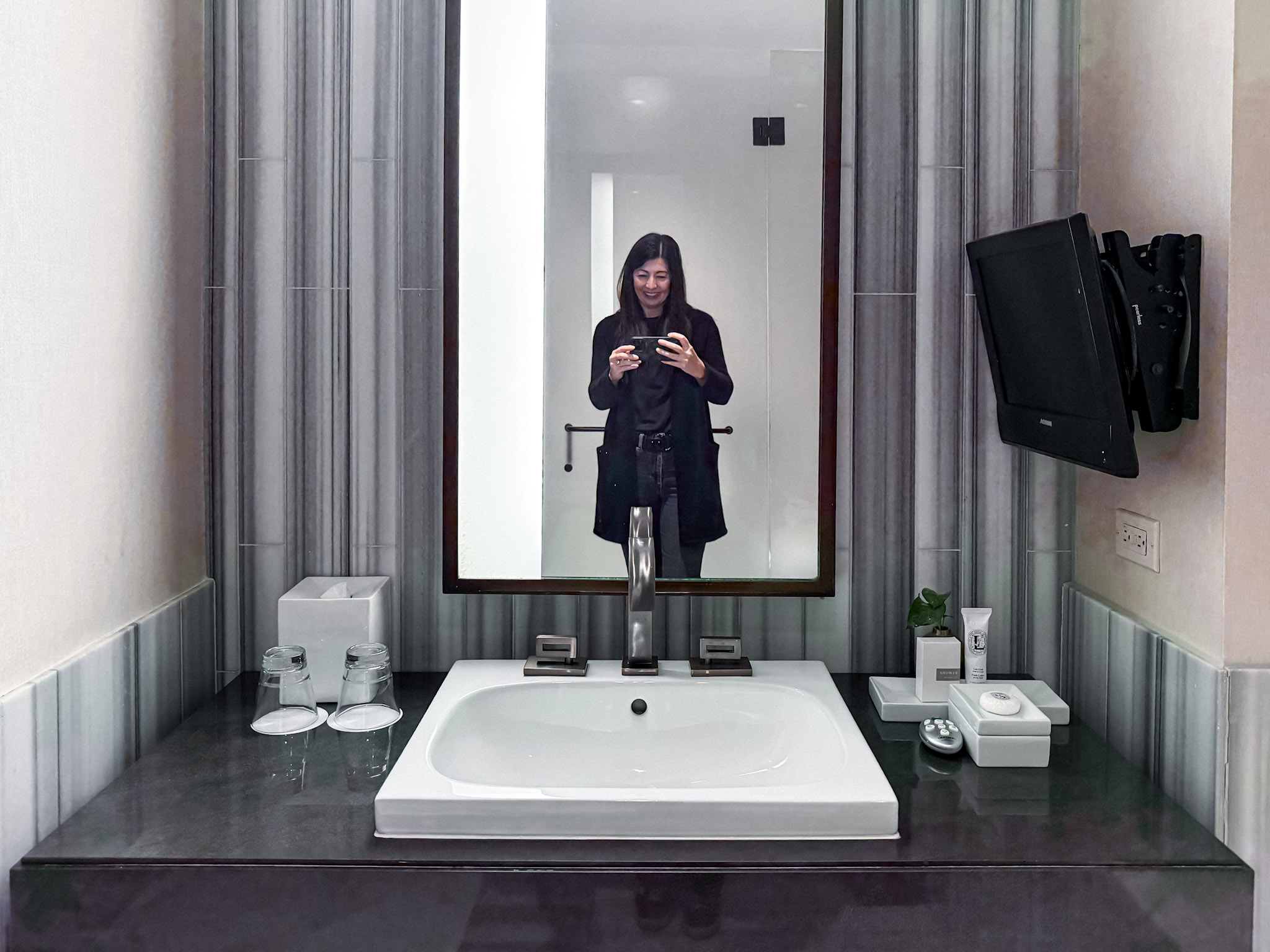The marble bathroom with me in the mirror.