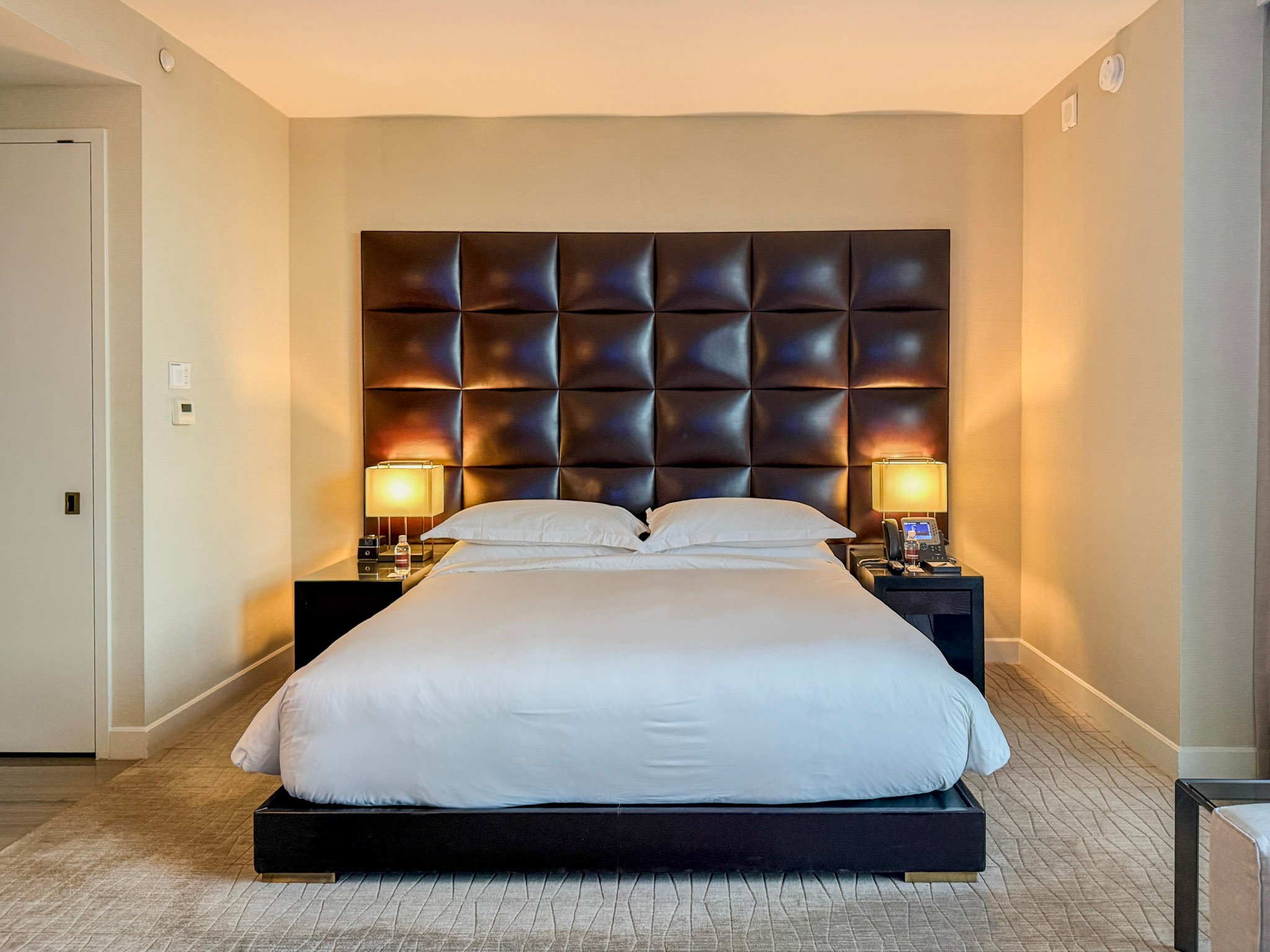 A king size bed in a SoHi room.