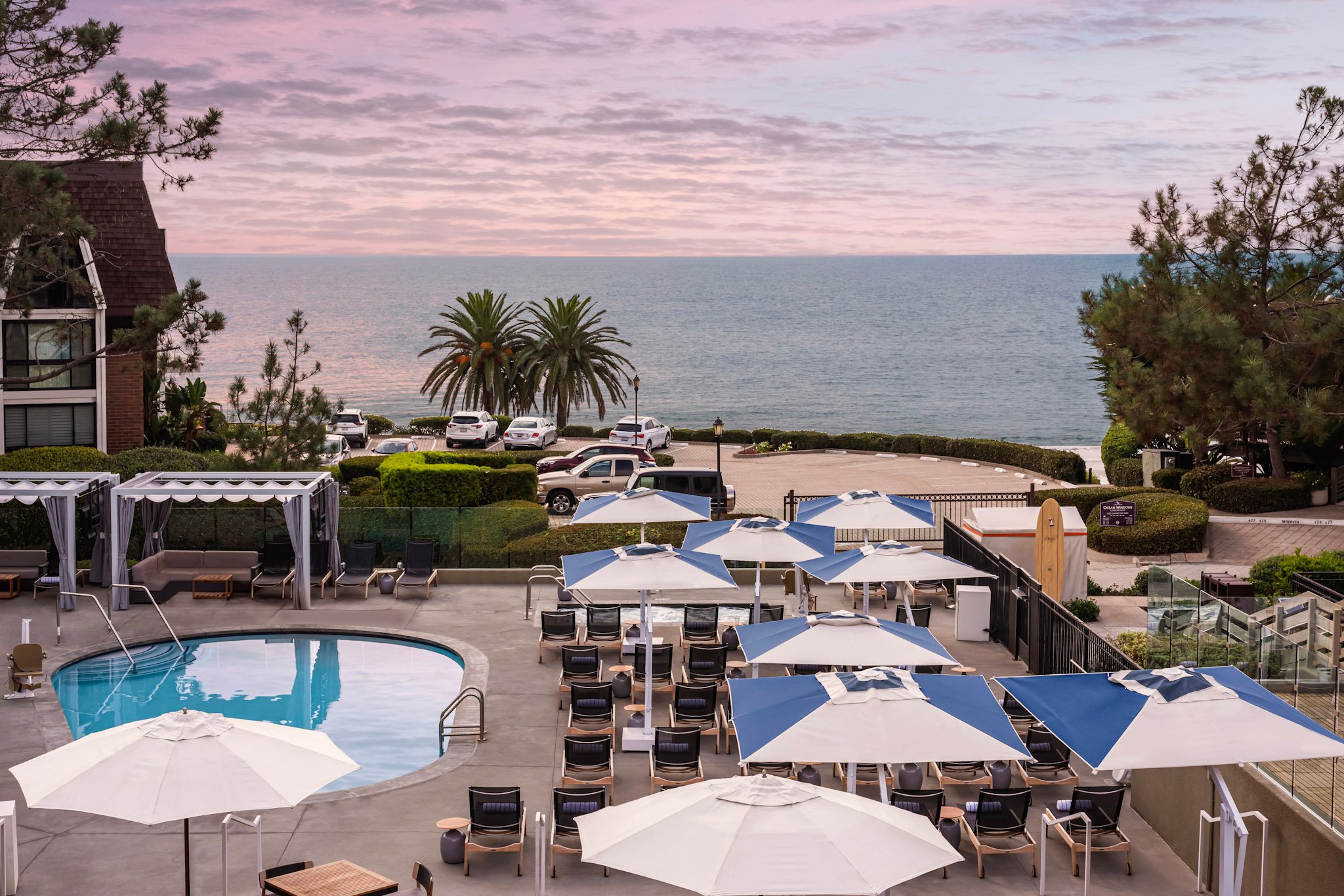 View over the L'Auberge Del Mar pool deck to the ocean at sunset.