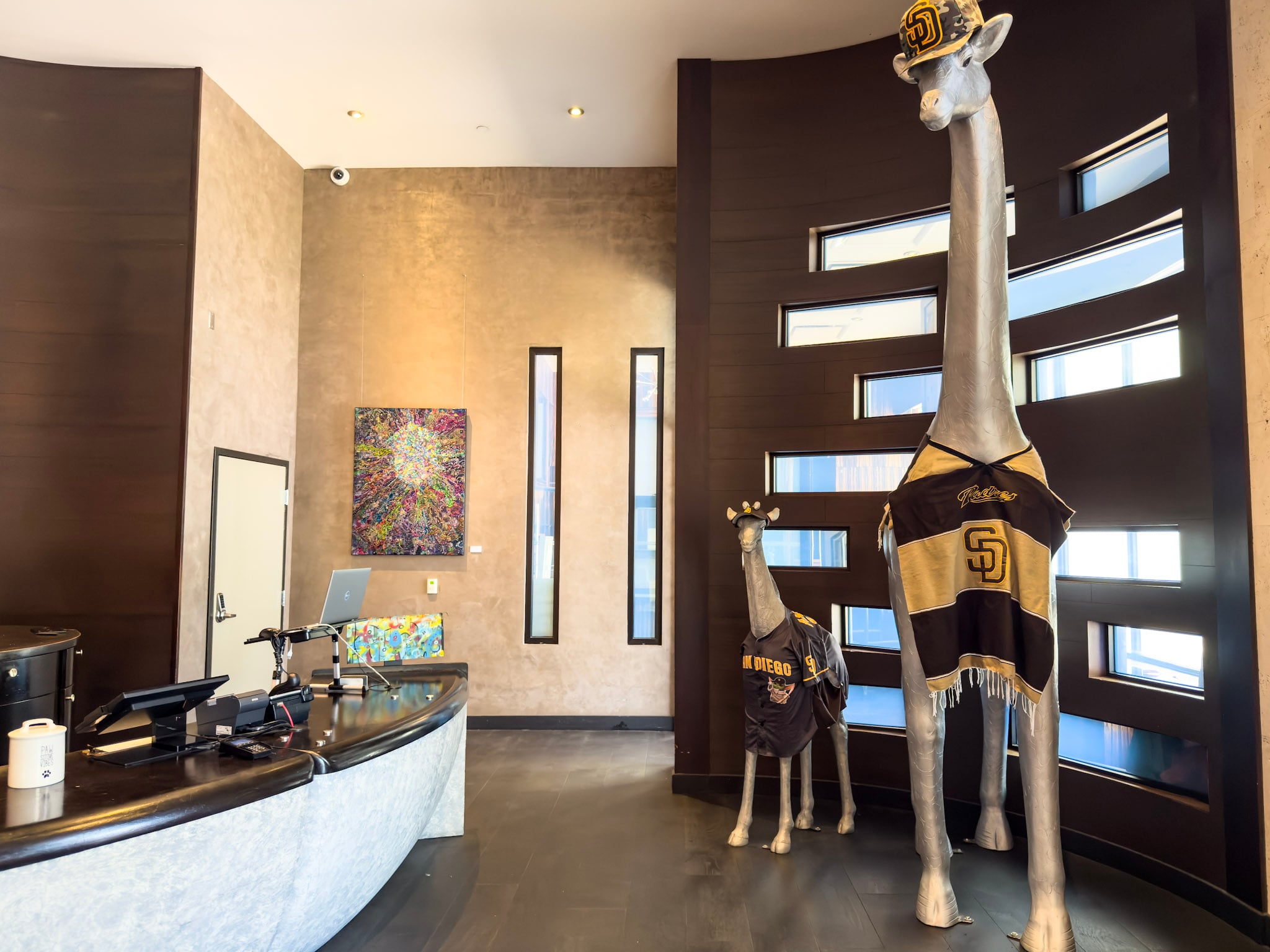 Giraffe statues wearing Padres gear in the lobby at Andaz San Diego.