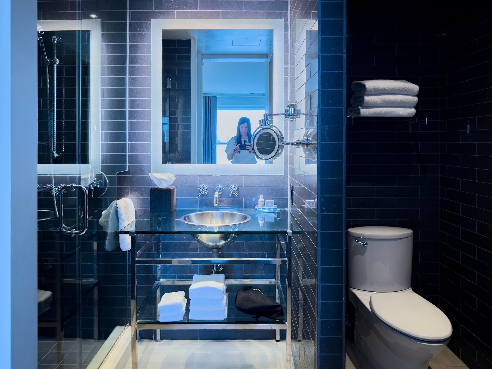 My modern Andaz Suite bathroom with black tile walls.