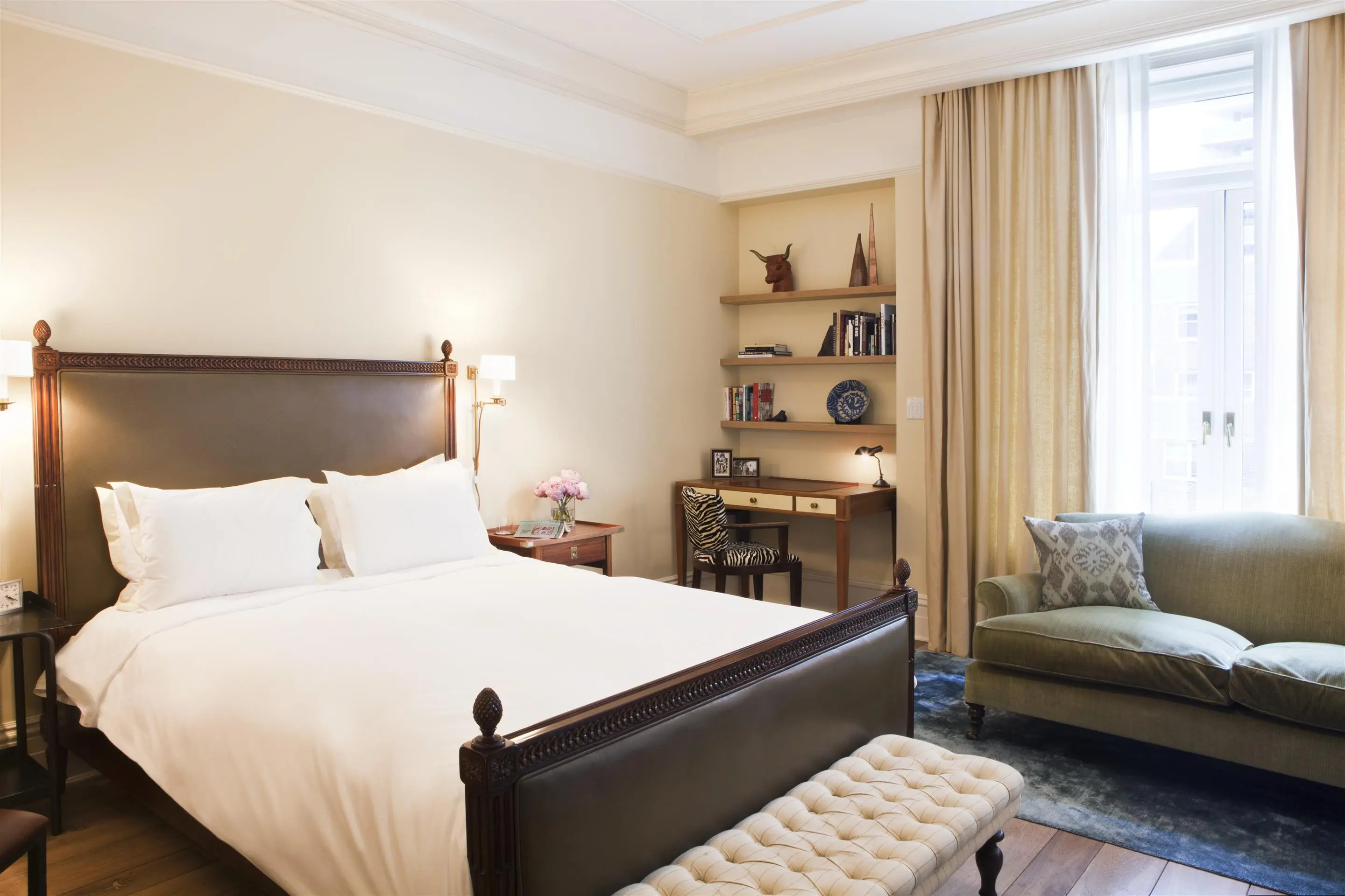 King room interior with cozy sofa, full windows, and plenty of light at The Greenwich Hotel.