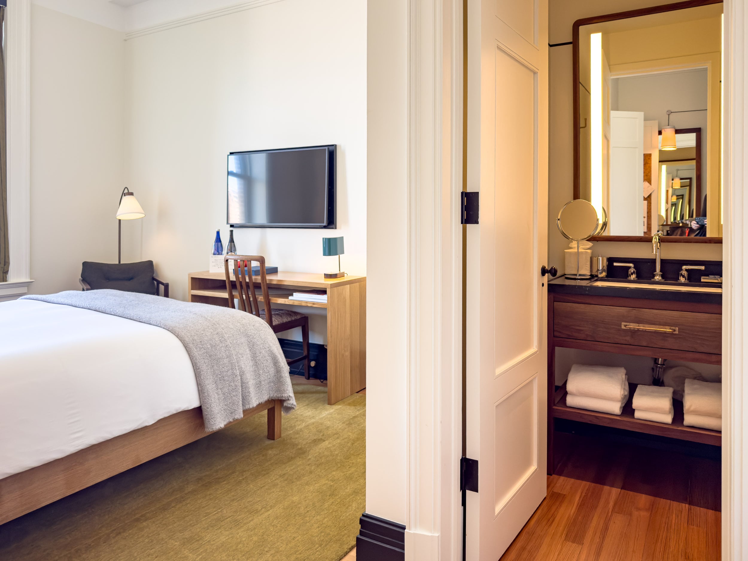 Classic Queen room at Nine Orchard showing the desk, television and bathroom beyond