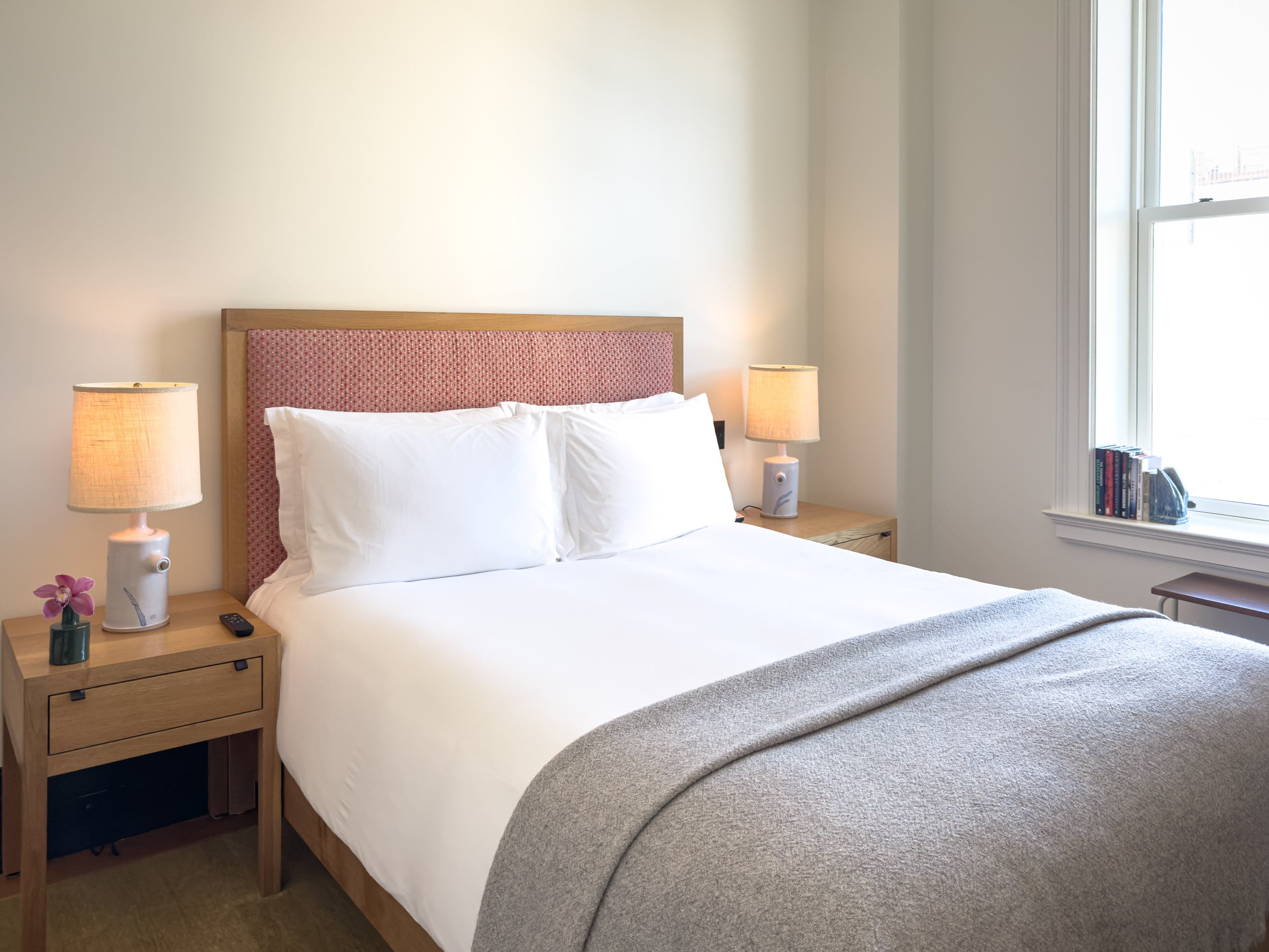 Classic Queen room at Nine Orchard with orchid, bedside lamps and window