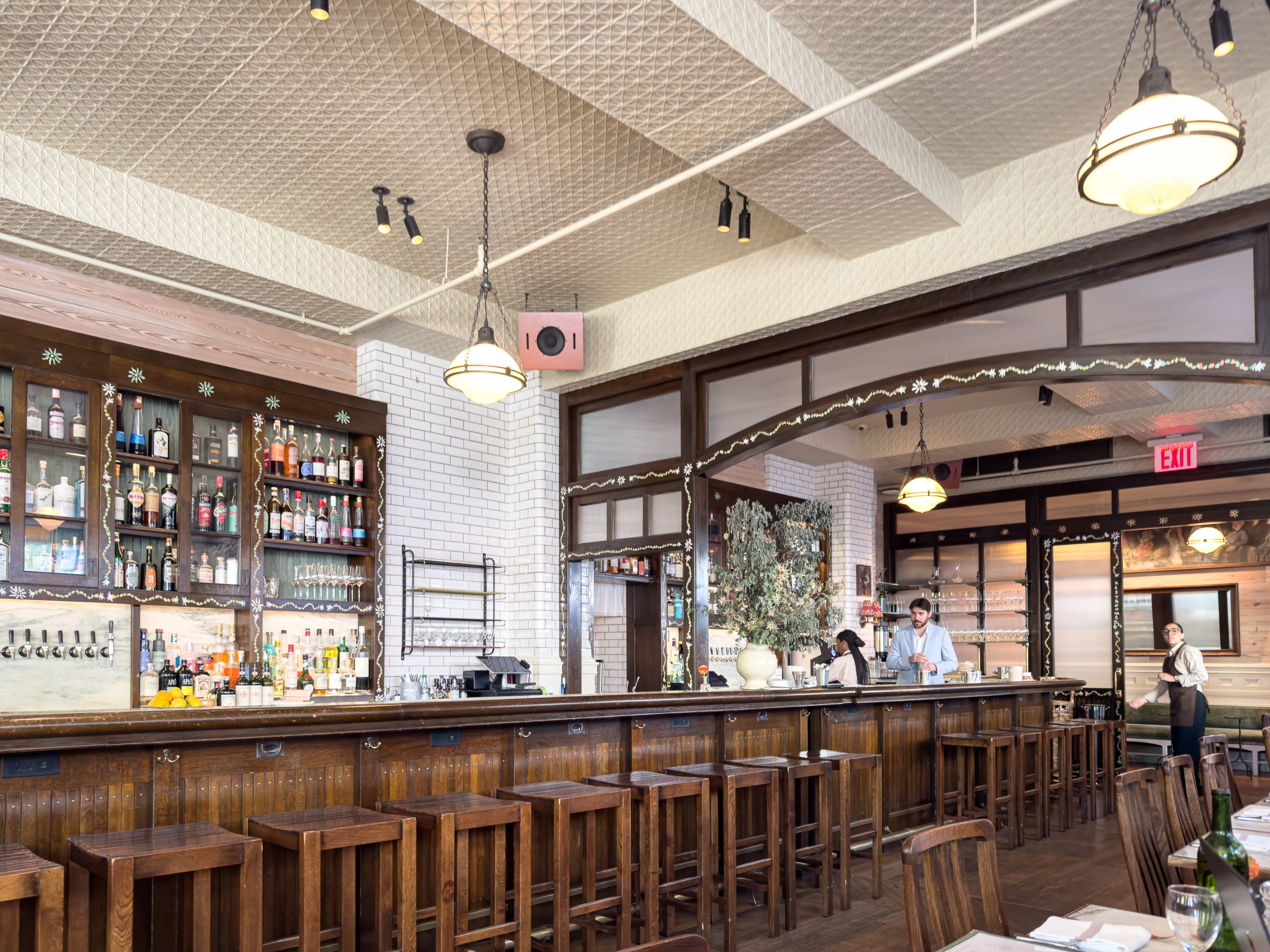 The bar and tiled ceiling at Corner Bar inside Nine Orchard