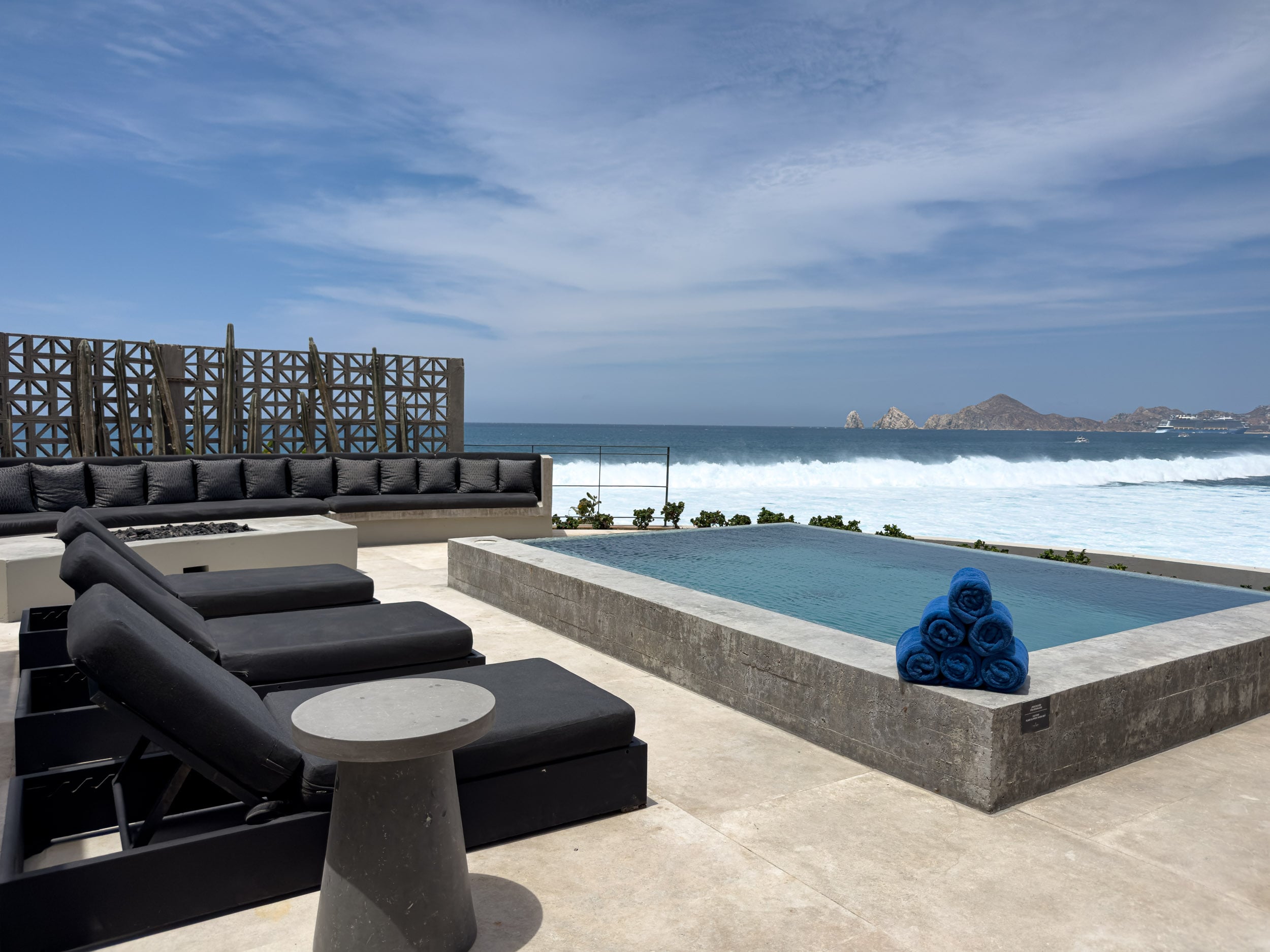 A private terrace and plunge pool at The Cape, with loungers looking out to the ocean and El Arco