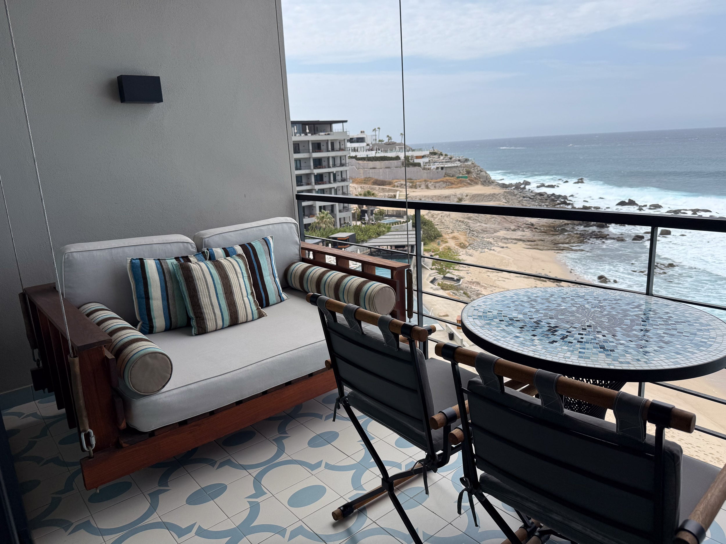 Balcony daybed and table overlooking the ocean at The Cape, a Thompson Hotel