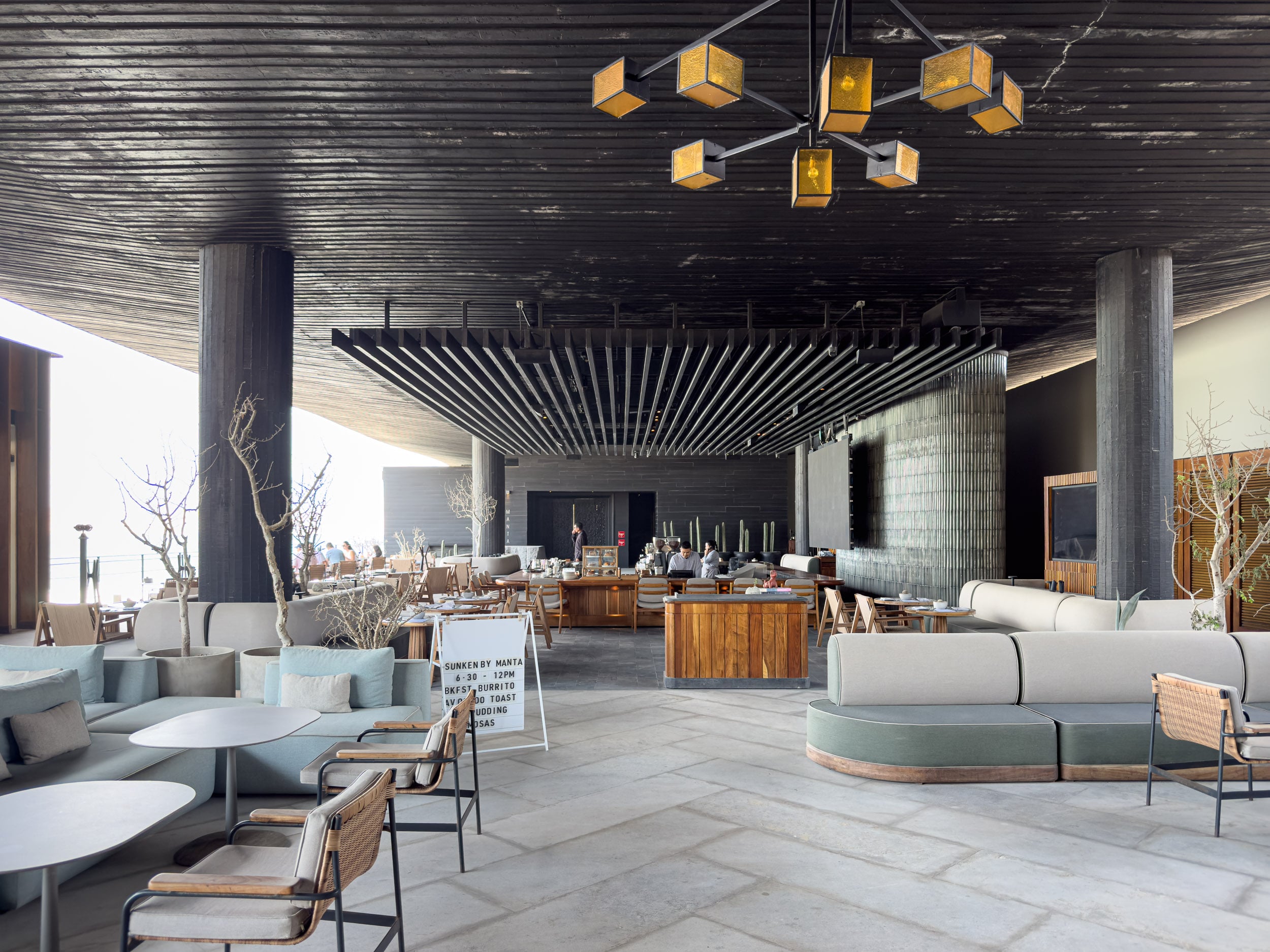 Open-air lobby lounge with sculptural wood ceiling at The Cape, a Thompson Hotel