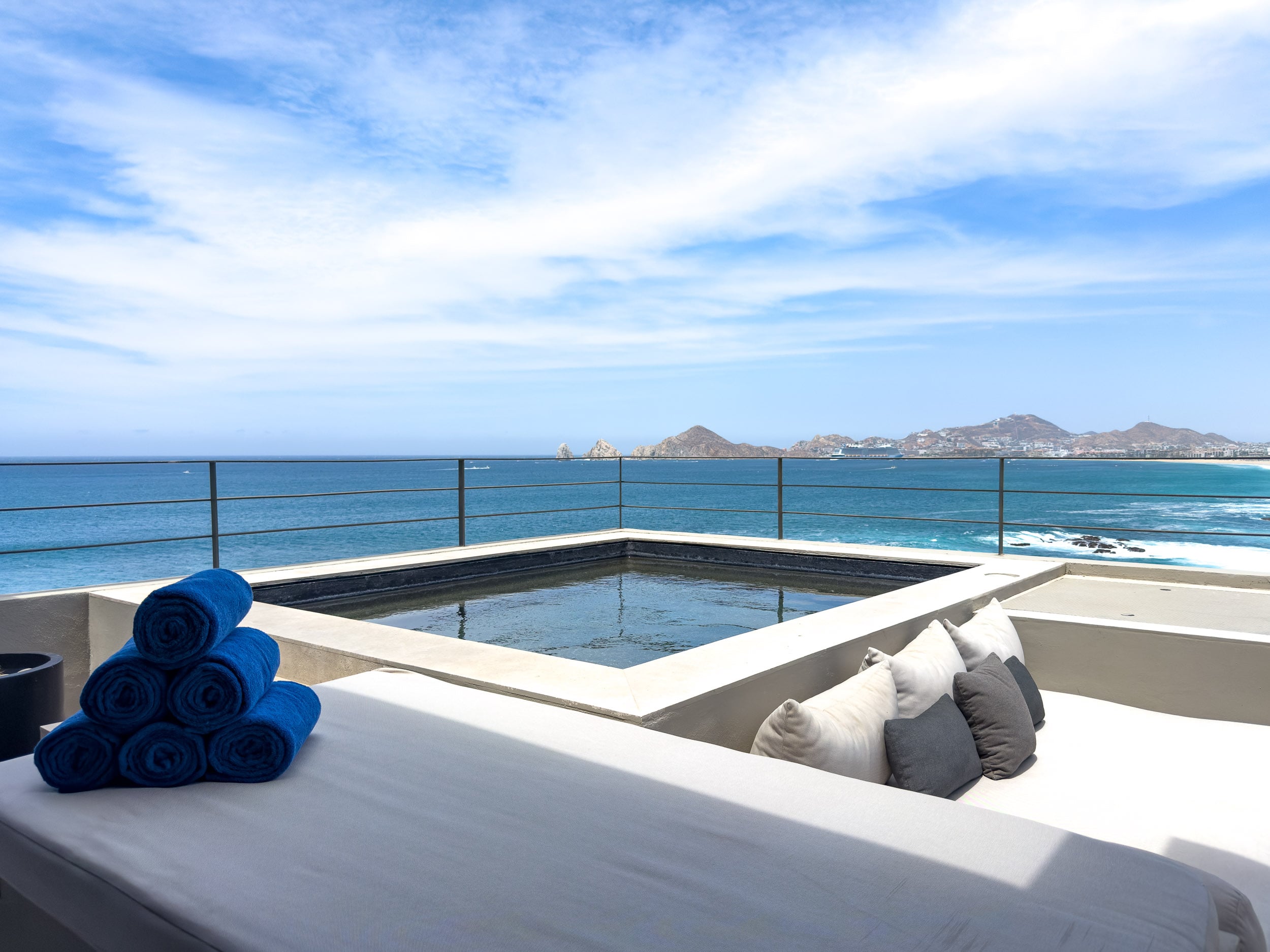 Private plunge pool with rolled blue towels and a daybed overlooking the Pacific at The Cape, a Thompson Hotel in Cabo San Lucas
