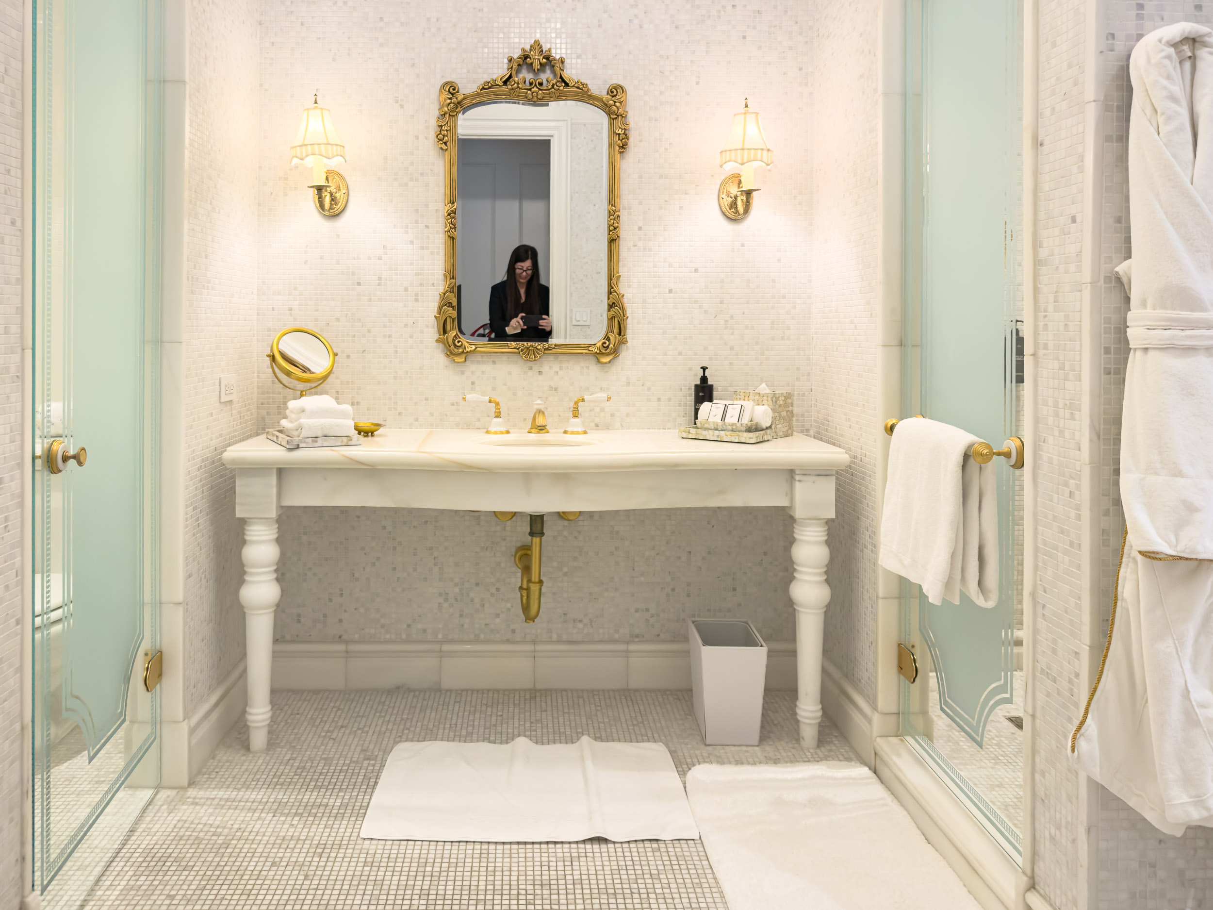 Bathroom vanity with gilt mirror and marble counter at The Plaza Hotel New York