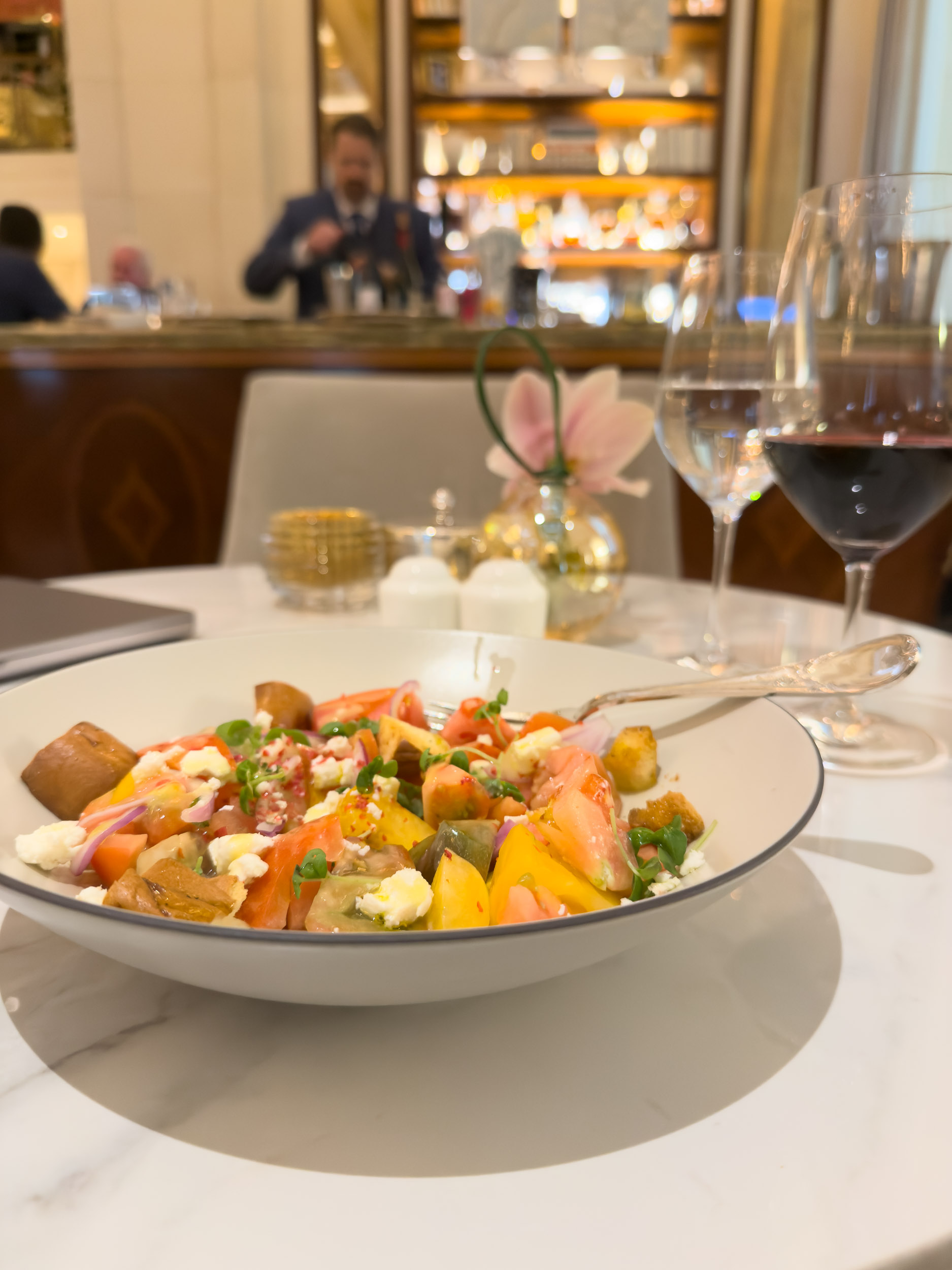 Plated seasonal dish with wine at a restaurant inside The Plaza Hotel New York