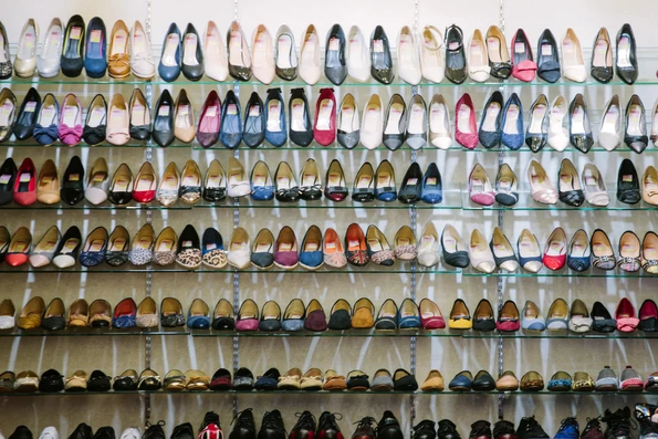 A display of shoes on sale in a store - use Goo Gone to remove sale stickers off the soles of shoes.